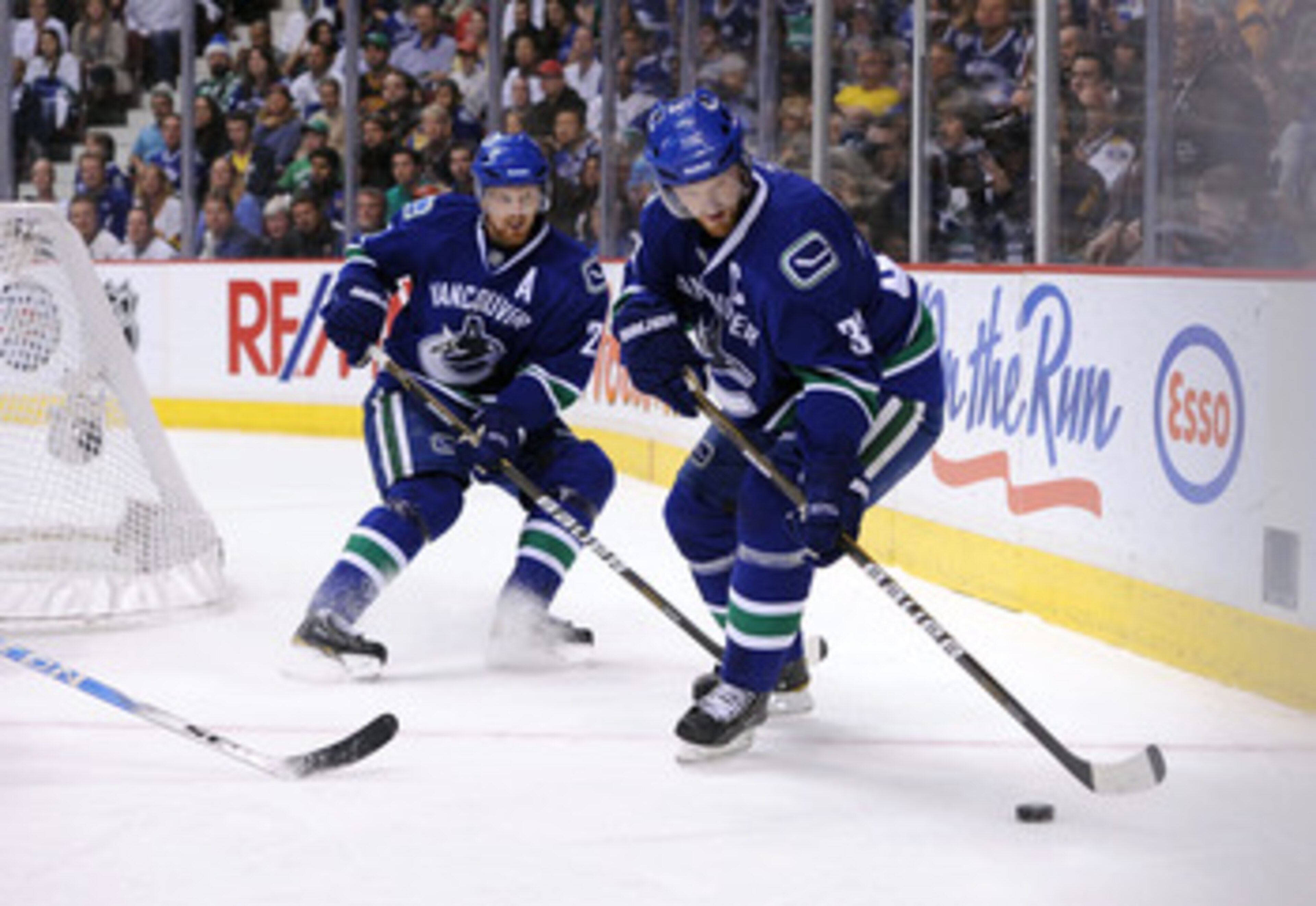 VANCOUVER, CANADA - MAY 24: Henrik Sedin #33 of the Vancouver Canucks controls the puck as teammate Daniel Sedin #22 looks on in Game Five of the Western Conference Finals against the San Jose Sharks during the 2011 Stanley Cup Playoffs at Rogers Arena o VANCOUVER, CANADA - MAY 24: Henrik Sedin #33 of the Vancouver Canucks controls the puck as teammate Daniel Sedin #22 looks on in Game Five of the Western Conference Finals against the San Jose Sharks during the 2011 Stanley Cup Playoffs at Rogers Arena o