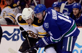 VANCOUVER, CANADA - FEBRUARY 26: Alexandre Burrows #14 of the Vancouver Canucks gets in close to Milan Lucic #17 of the Boston Bruins on a face-off during the third period in NHL action on February 26, 2011 at Rogers Arena in Vancouver, British Columbia,