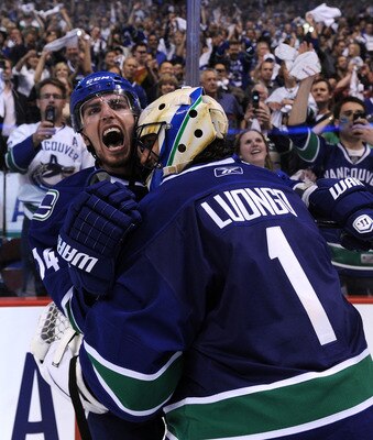 VANCOUVER, CANADA - MAY 24:  Alex Burrows #14 and goaltender Roberto Luongo #1 of the Vancouver Canucks celebrate after defeating the San Jose Sharks 3-2 in double-overtime in Game Five to win the Western Conference Finals during the 2011 Stanley Cup Play