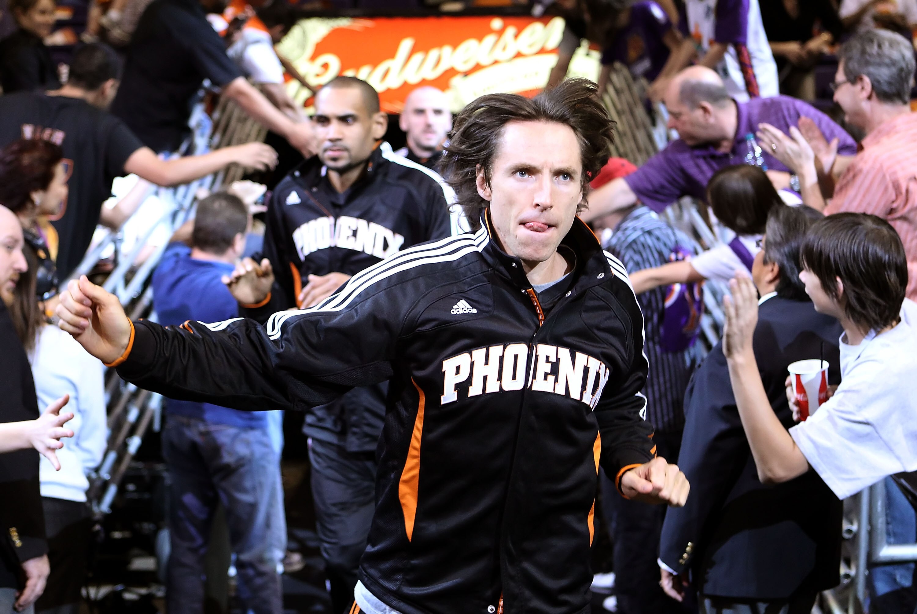 PHOENIX, AZ - APRIL 13:  Steve Nash #13 of the Phoenix Suns runs out onto the court for warm ups to the NBA game against the San Antonio Spurs at US Airways Center on April 13, 2011 in Phoenix, Arizona.  NOTE TO USER: User expressly acknowledges and agree