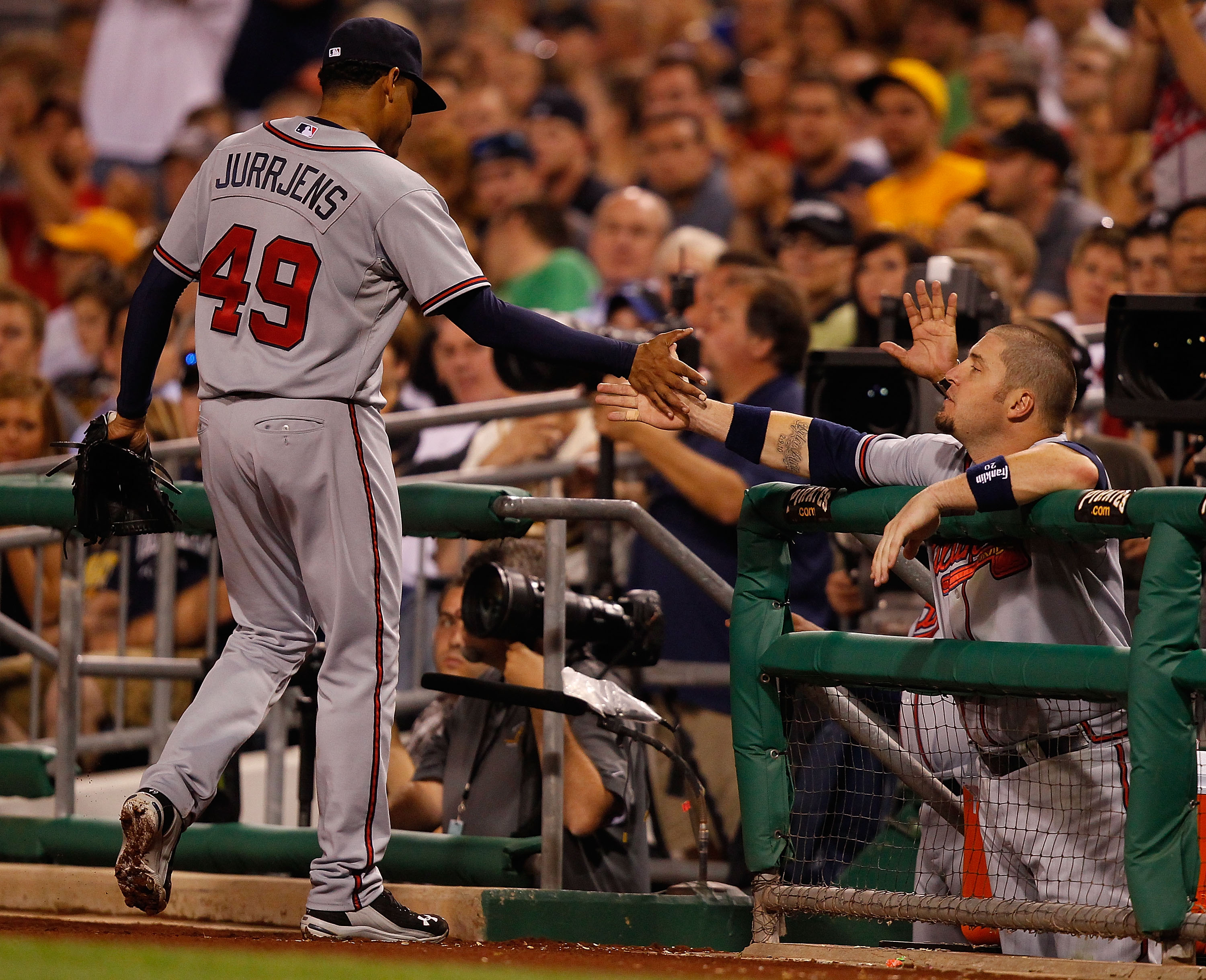 PITTSBURGH - MAY 24:  Jair Jurrjens #49 of the Atlanta Braves is congratulated by teammate Eric Hinske #20 after being relieved in the 8th inning against the Pittsburgh Pirates during the game on May 24, 2011 at PNC Park in Pittsburgh, Pennsylvania.  (Pho