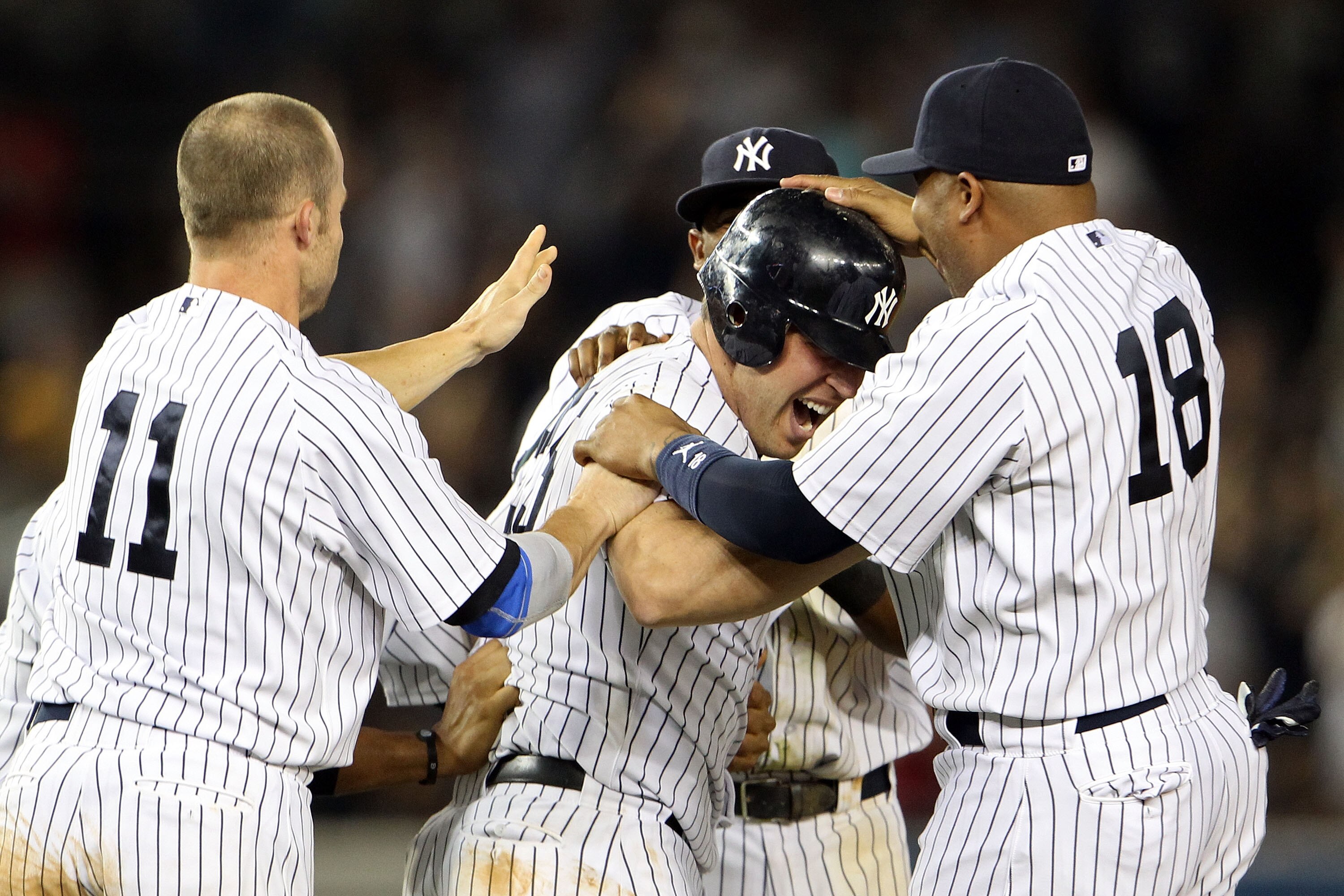 NEW YORK, NY - MAY 24:  Mark Teixeira #25 of the New York Yankees celebrates with Brett Gardner #11 and Andruw Jones #18 after hitting a game winning RBI in the ninth inning against the Toronto Blue Jays at Yankee Stadium on May 24, 2011 in the Bronx boro