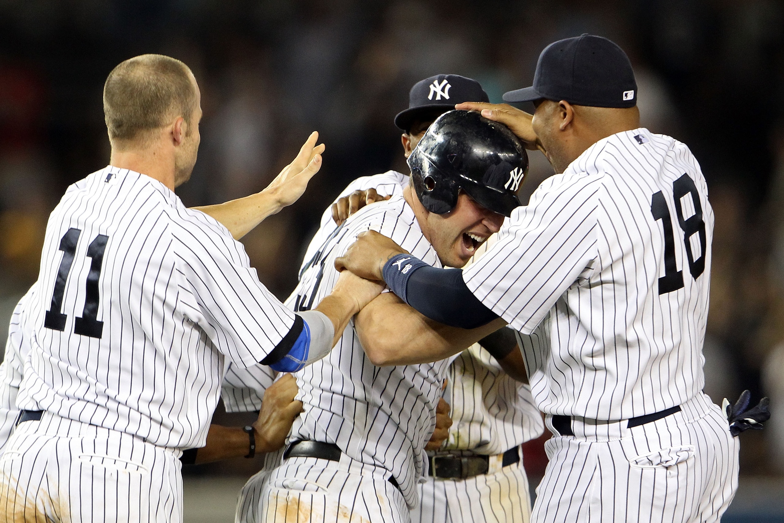 NEW YORK, NY - MAY 24:  Mark Teixeira #25 of the New York Yankees celebrates with Brett Gardner #11 and Andruw Jones #18 after hitting a game winning RBI in the ninth inning against the Toronto Blue Jays at Yankee Stadium on May 24, 2011 in the Bronx boro
