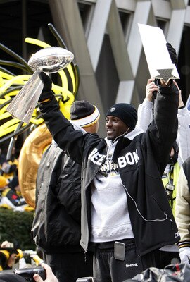 PITTSBURGH - FEBRUARY 03:  Santonio Holmes #10 of the Pittsburgh Steelers holds up his MVP and the Lombardi trophy after a parade to celebrate winning Super Bowl XLIII on February 3, 2009 in Pittsburgh, Pennsylvania.  (Photo by Gregory Shamus/Getty Images