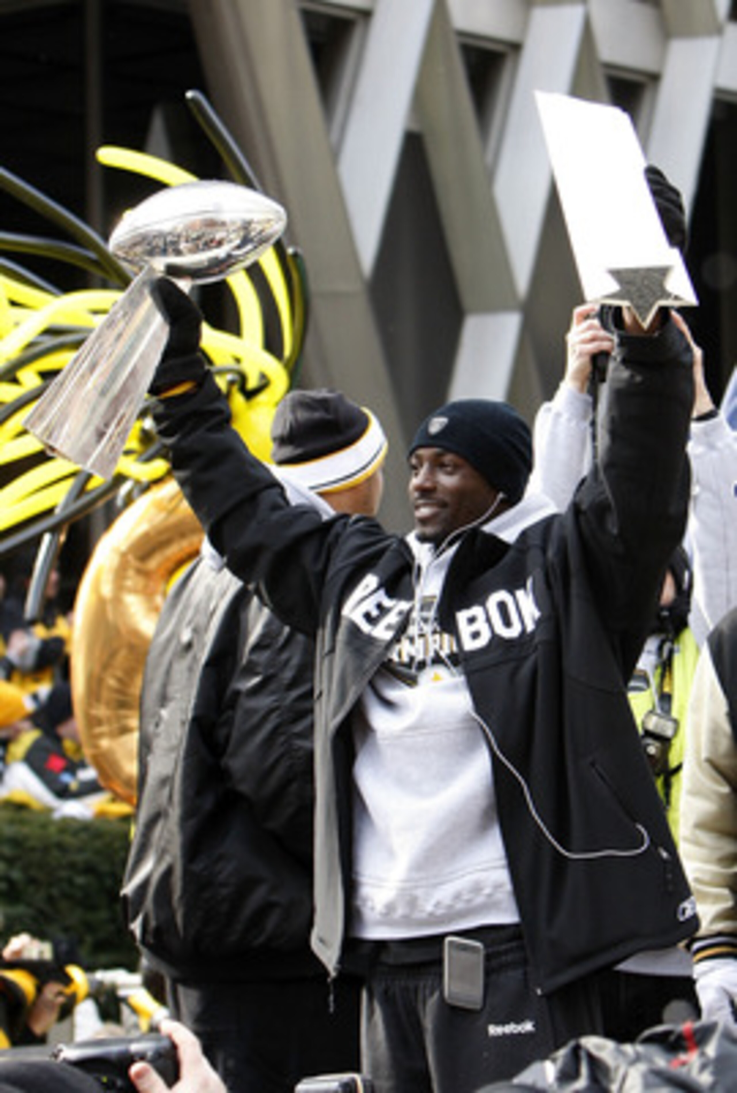 PITTSBURGH - FEBRUARY 03:  Santonio Holmes #10 of the Pittsburgh Steelers holds up his MVP and the Lombardi trophy after a parade to celebrate winning Super Bowl XLIII on February 3, 2009 in Pittsburgh, Pennsylvania.  (Photo by Gregory Shamus/Getty Images
