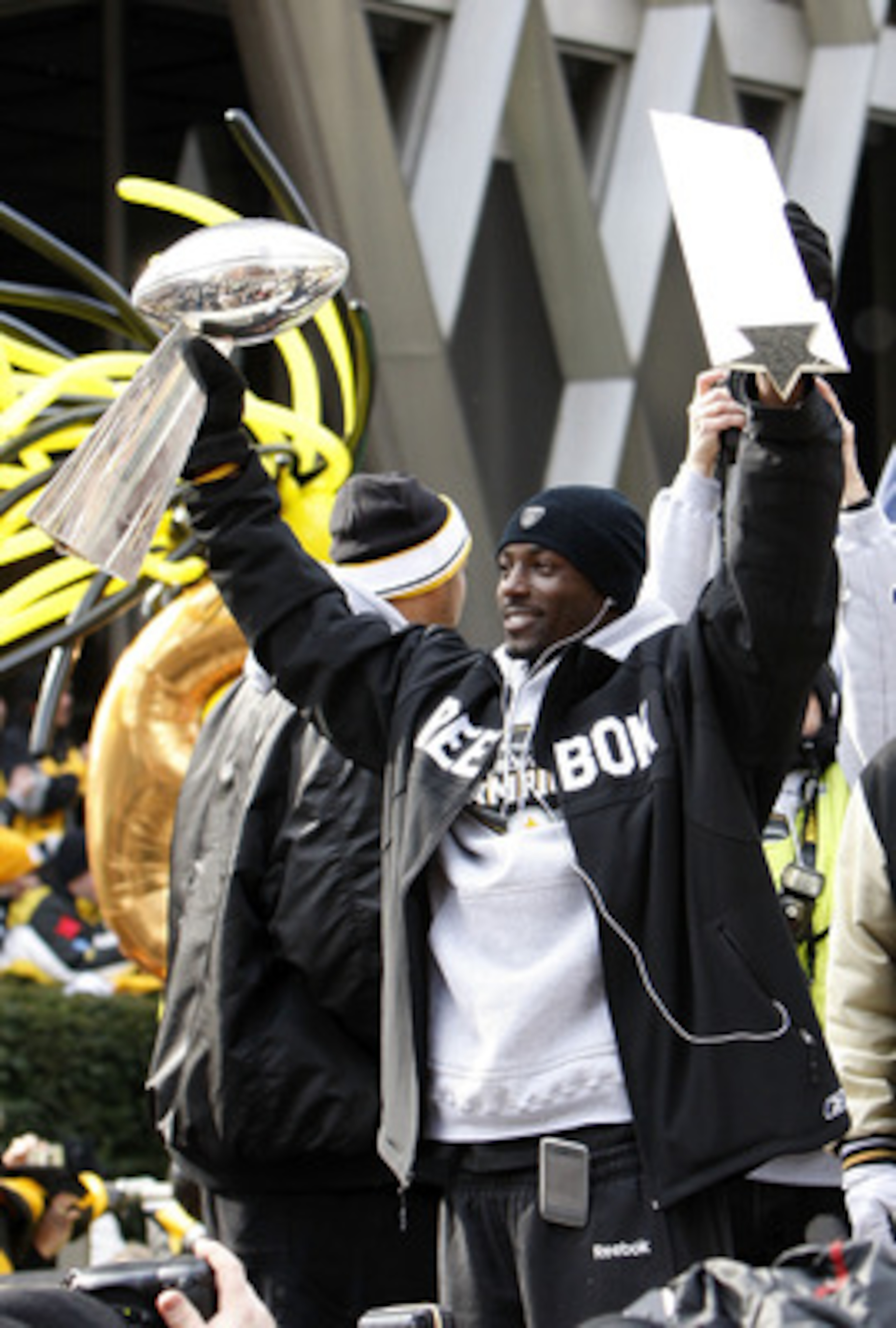 PITTSBURGH - FEBRUARY 03:  Santonio Holmes #10 of the Pittsburgh Steelers holds up his MVP and the Lombardi trophy after a parade to celebrate winning Super Bowl XLIII on February 3, 2009 in Pittsburgh, Pennsylvania.  (Photo by Gregory Shamus/Getty Images
