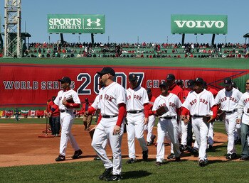 BOSTON - APRIL 08:  The Boston Red Sox  head to the dugout after raising the 2007 World Series banner and carrying their championship rings before the game against the Detroit Tigers on April 8,2008 during Opening Day at Fenway Park in Boston, Massachuset