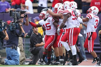 SEATTLE - SEPTEMBER 18:  Cornerback Alfonzo Dennard #15 of the Nebraska Cornhuskers is mobbed by teammates after returning an interception 31 yards for a touchdown in the third quarter against the Washington Huskies on September 18, 2010 at Husky Stadium 