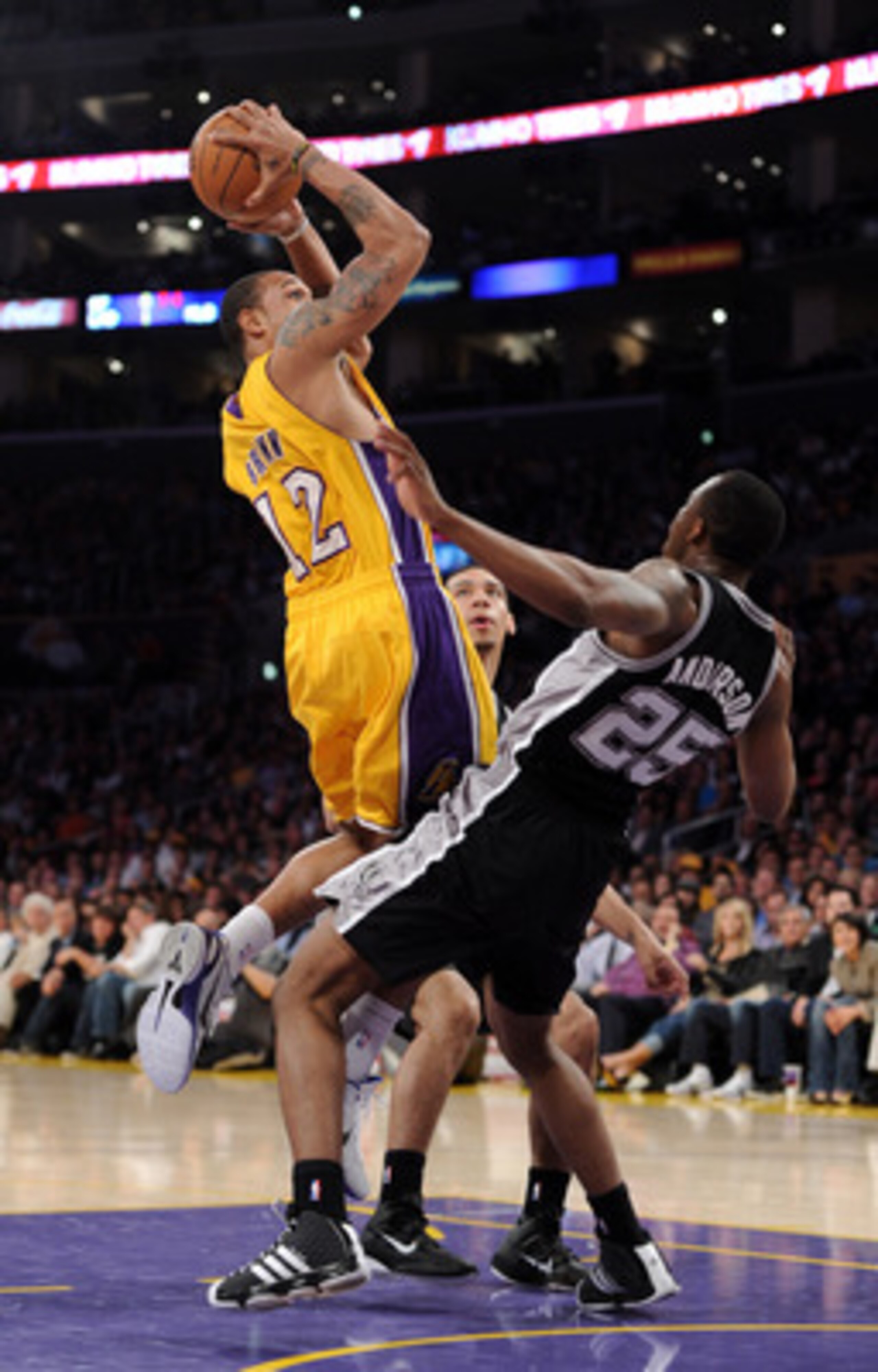 LOS ANGELES, CA - APRIL 12:  Shannon Brown #12 of the Los Angeles Lakers is called for a charging foul on James Anderson #25 of the San Antonio Spurs at Staples Center on April 12, 2011 in Los Angeles, California.  NOTE TO USER: User expressly acknowledge