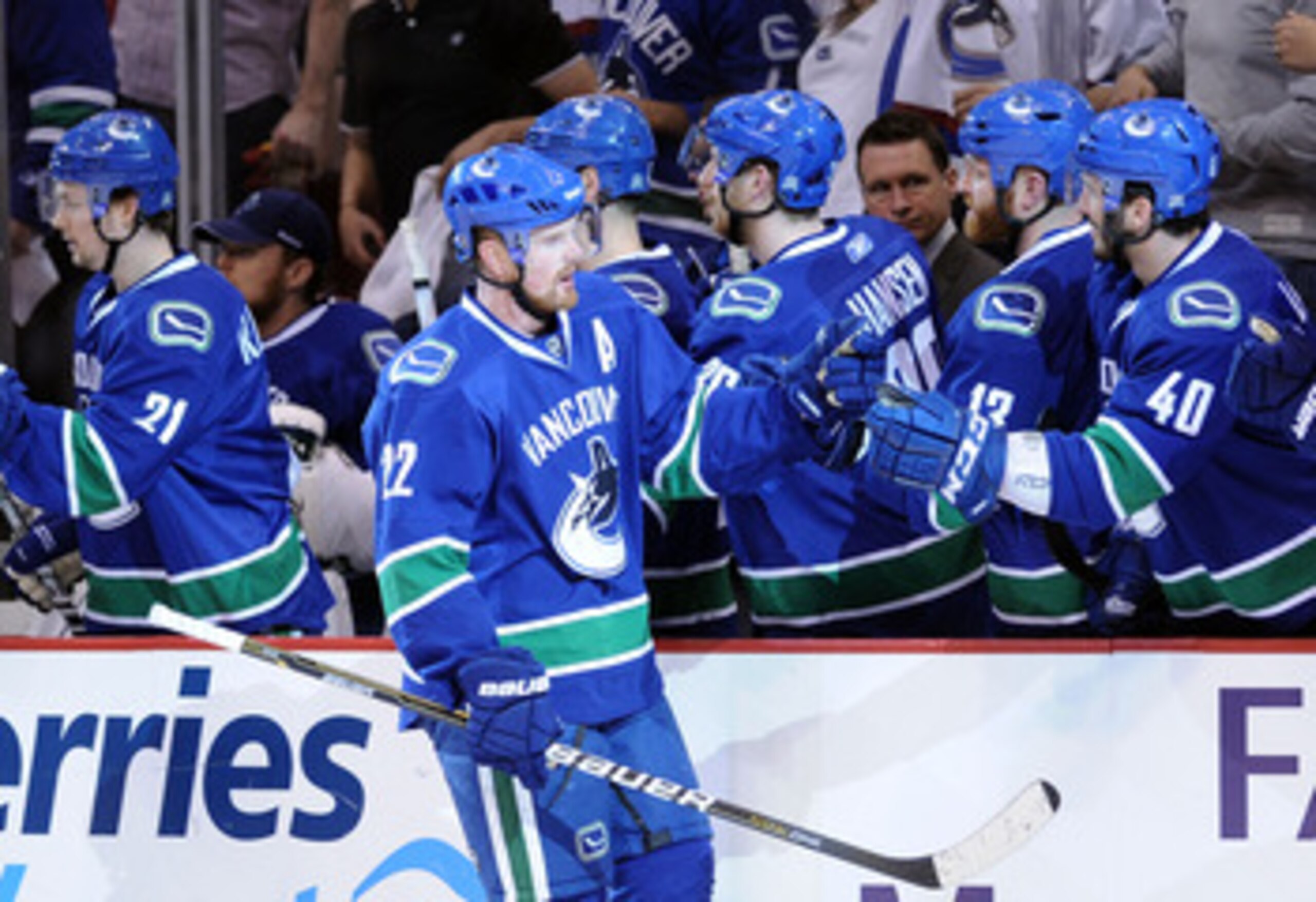 VANCOUVER, CANADA - MAY 18:  Daniel Sedin #22 of the Vancouver Canucks skates by the Canucks bench to celebrate his first period goal with teammates in Game Two of the Western Conference Finals against the San Jose Sharks during the 2011 Stanley Cup Playo