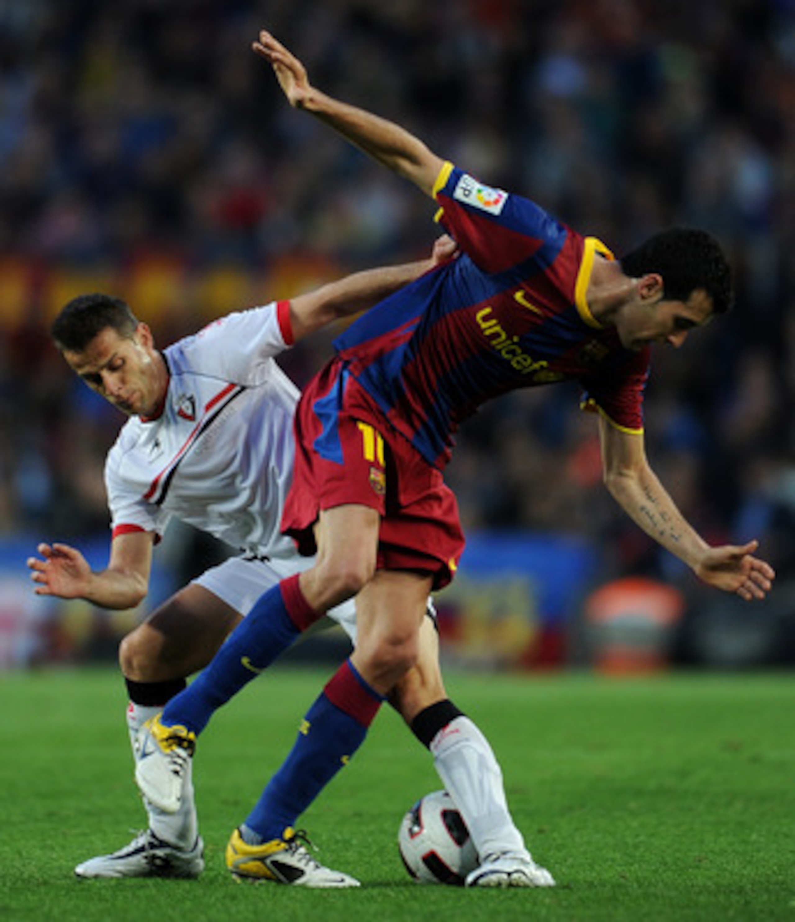 BARCELONA, SPAIN - APRIL 23:  Sergio Busquets (R) of Barcelona duels for the ball with Damia Perez of Osasuna during the la Liga match between Barcelona and Osasuna at the Camp Nou stadium on April 23, 2011 in Barcelona, Spain.  (Photo by Jasper Juinen/Ge