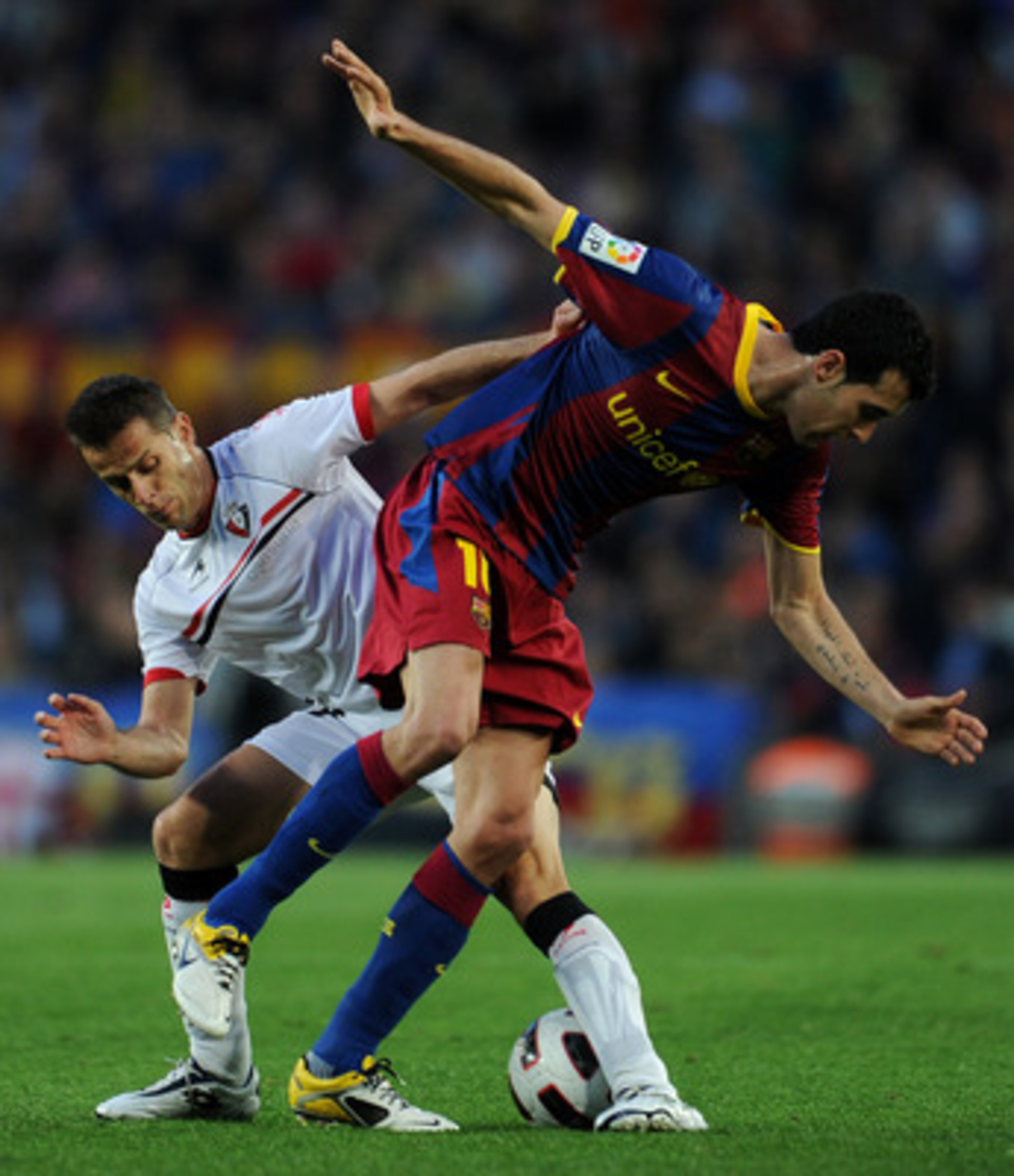 BARCELONA, SPAIN - APRIL 23: Sergio Busquets (R) of Barcelona duels for the ball with Damia Perez of Osasuna during the la Liga match between Barcelona and Osasuna at the Camp Nou stadium on April 23, 2011 in Barcelona, Spain. (Photo by Jasper Juinen/Ge BARCELONA, SPAIN - APRIL 23: Sergio Busquets (R) of Barcelona duels for the ball with Damia Perez of Osasuna during the la Liga match between Barcelona and Osasuna at the Camp Nou stadium on April 23, 2011 in Barcelona, Spain. (Photo by Jasper Juinen/Ge