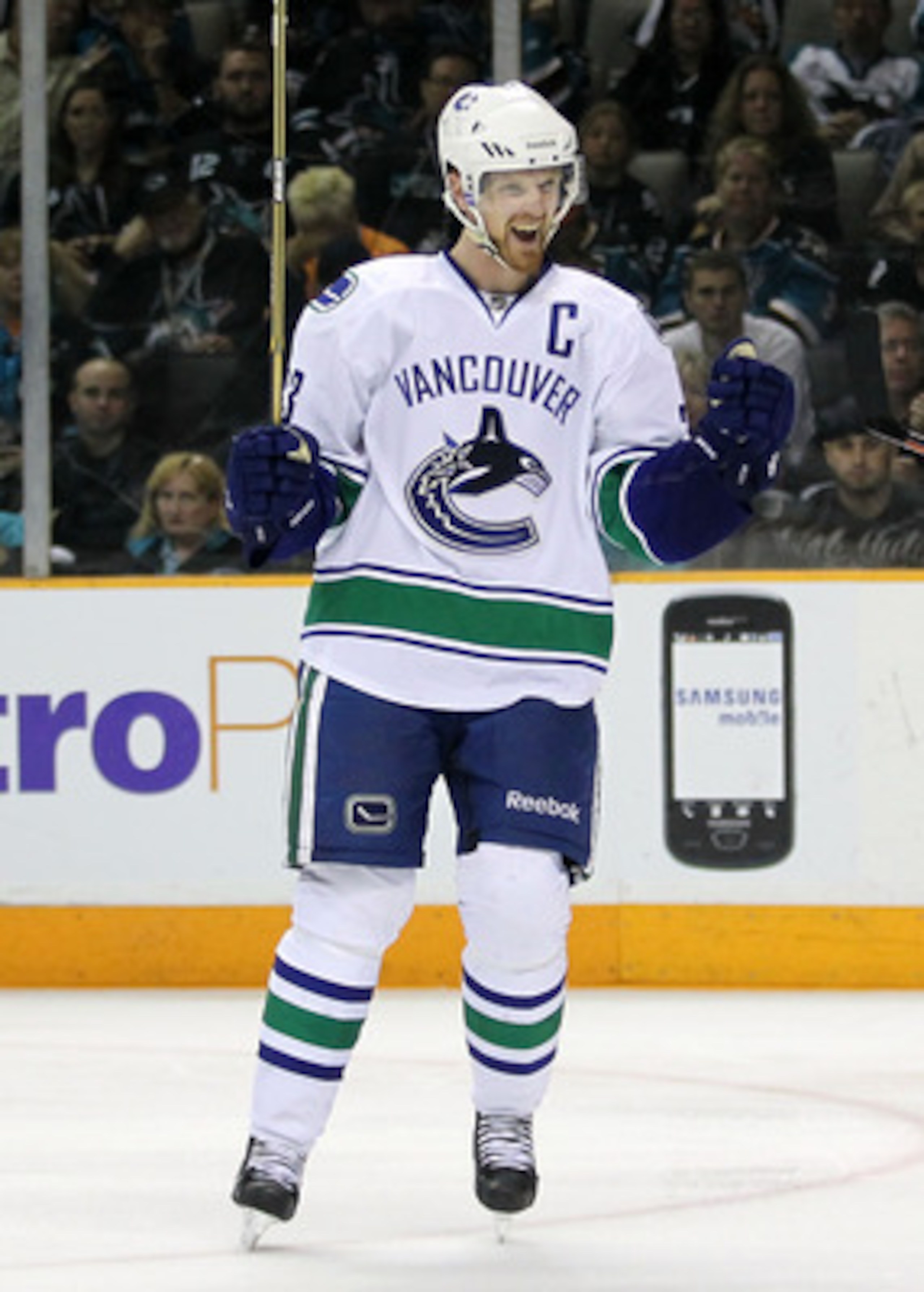 SAN JOSE, CA - MAY 22:  Henrik Sedin #33 of the Vancouver Canucks celebrates after assisting on a scoring play to teammate Alex Burrows #14 in the third period in Game Four of the Western Conference Finals against the San Jose Sharks during the 2011 Stanl