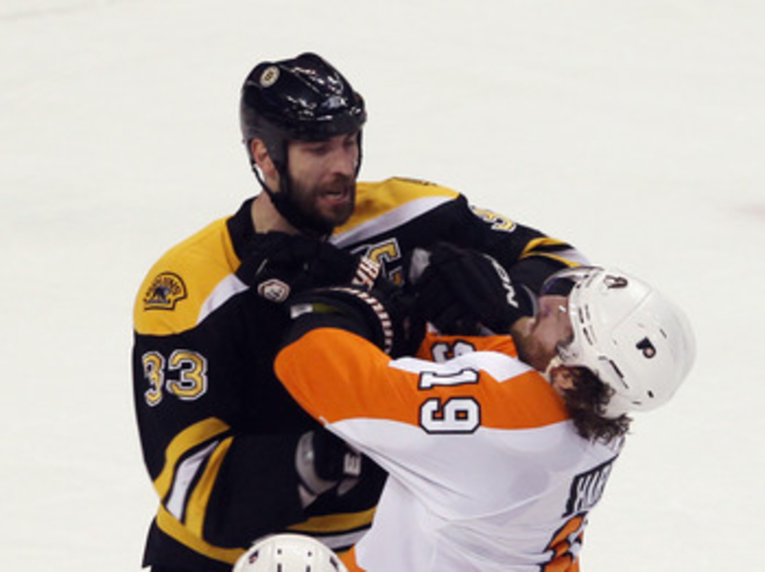 BOSTON, MA - MAY 06:  Zdeno Chara #33 of the Boston Bruins exchanges blows with Scott Hartnell #19 of the Philadelphia Flyers in Game Four of the Eastern Conference Semifinals during the 2011 NHL Stanley Cup Playoffs at TD Garden on May 6, 2011 in Boston,