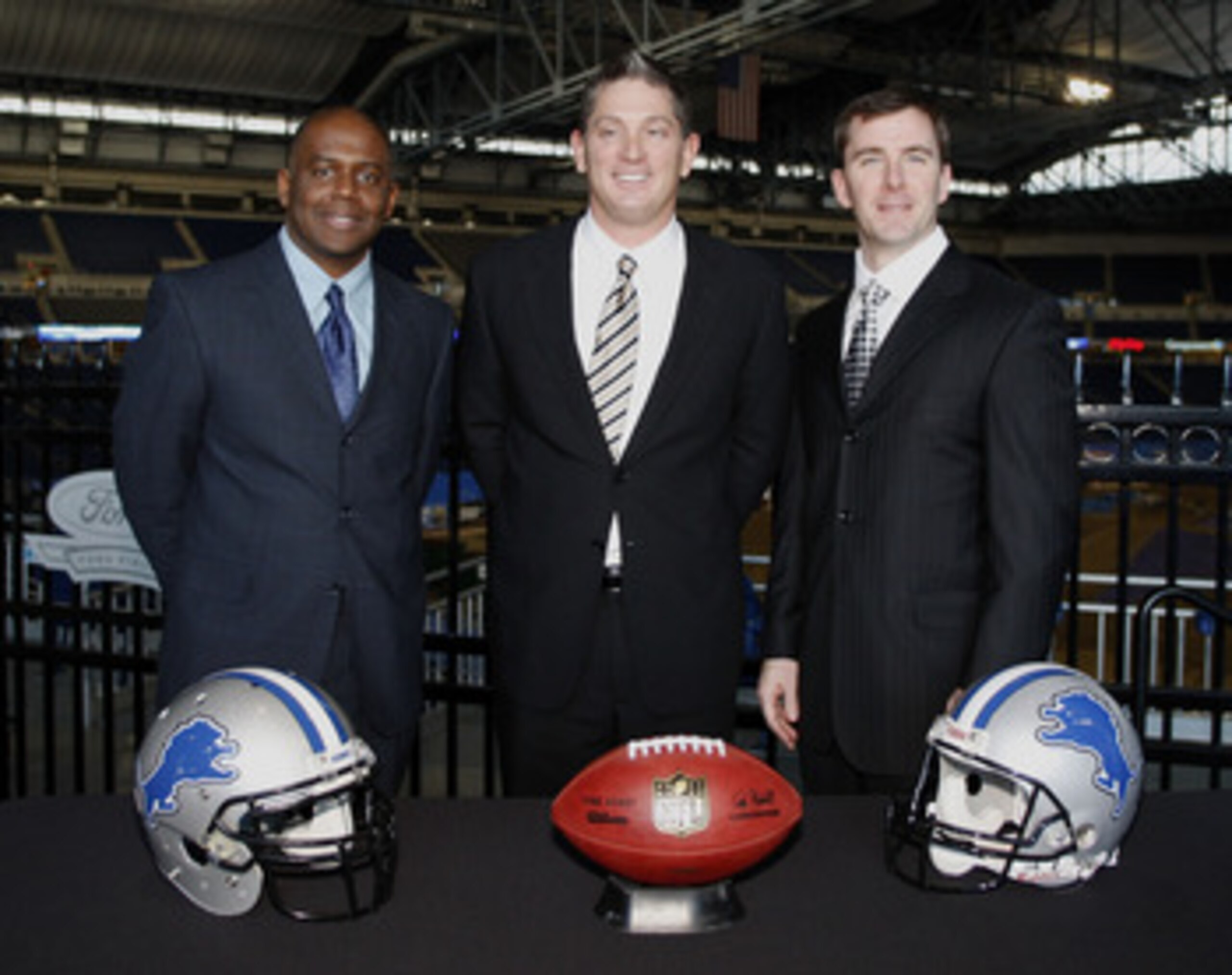 DETROIT , MI - JANUARY 16: Jim Schwartz, center, head coach of the Detroit Lions poses with General Manager Martin Mayhew, left, and Tom Lewand team president after a press conference to introduce him as the Lions new head coach on January 16, 2009 at Fo DETROIT , MI - JANUARY 16: Jim Schwartz, center, head coach of the Detroit Lions poses with General Manager Martin Mayhew, left, and Tom Lewand team president after a press conference to introduce him as the Lions new head coach on January 16, 2009 at Fo