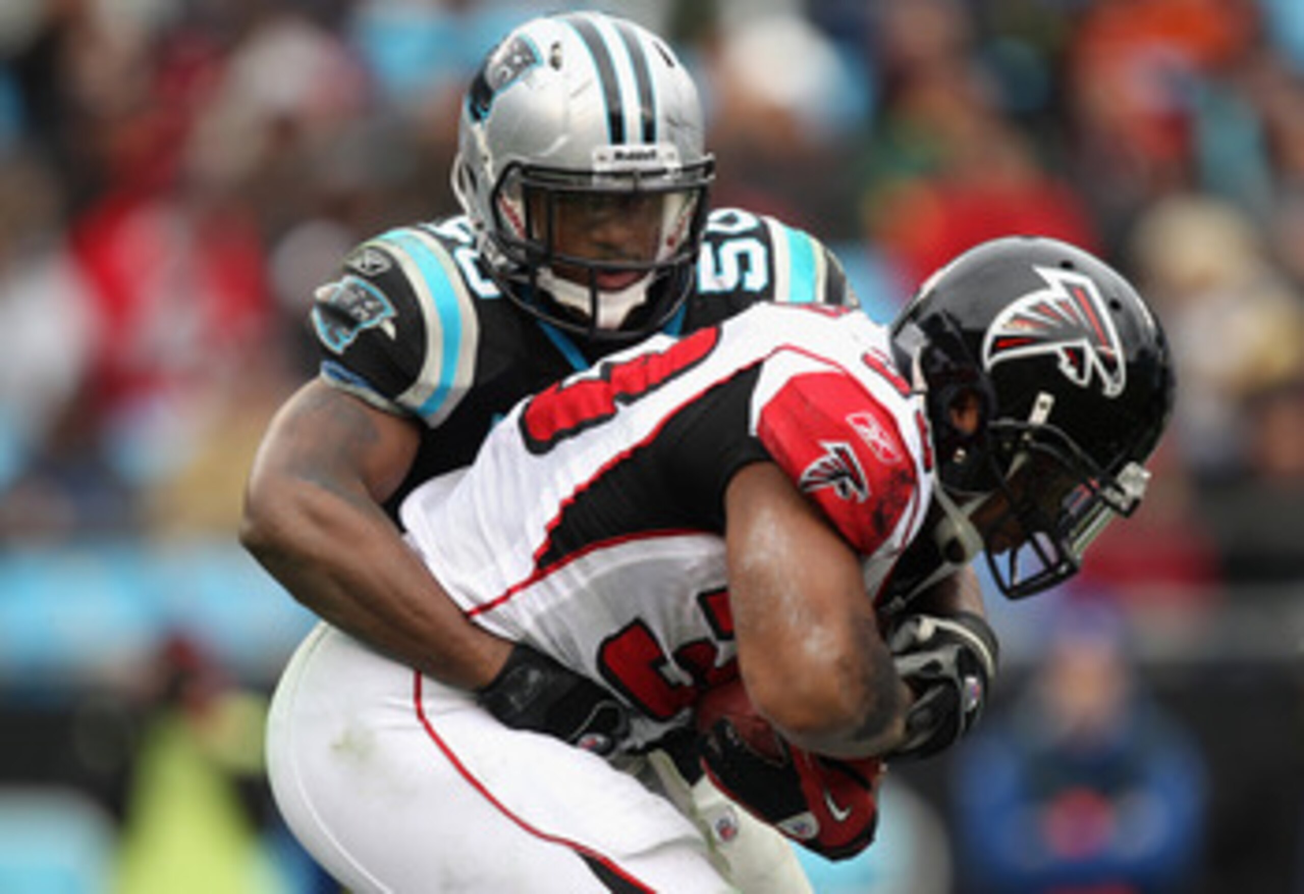 CHARLOTTE, NC - DECEMBER 12: Michael Turner #33 of the Atlanta Falcons is tackled by James Anderson #50 of the Carolina Panthers during their game at Bank of America Stadium on December 12, 2010 in Charlotte, North Carolina. (Photo by Streeter Lecka/Get CHARLOTTE, NC - DECEMBER 12: Michael Turner #33 of the Atlanta Falcons is tackled by James Anderson #50 of the Carolina Panthers during their game at Bank of America Stadium on December 12, 2010 in Charlotte, North Carolina. (Photo by Streeter Lecka/Get