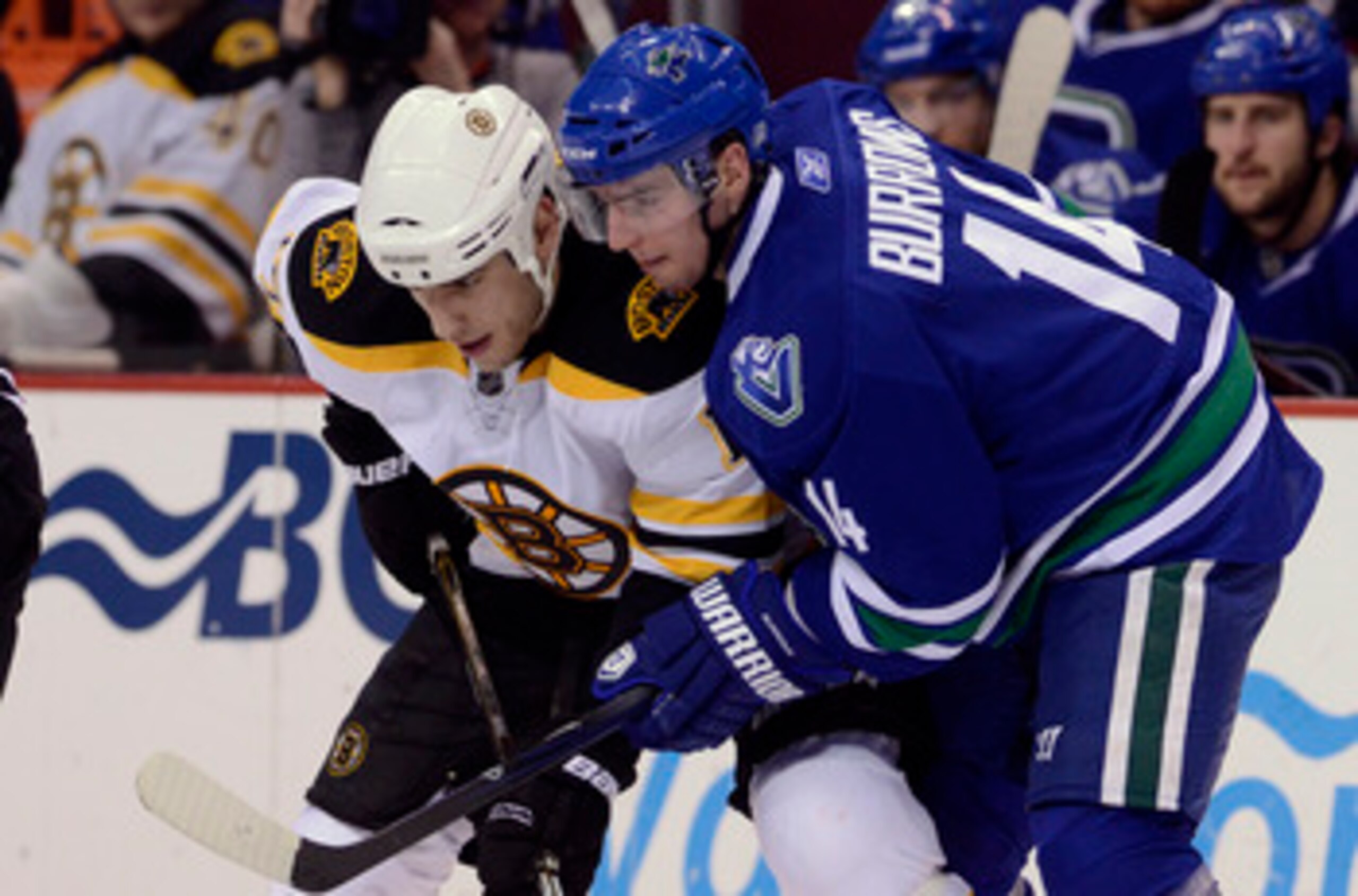 VANCOUVER, CANADA - FEBRUARY 26: Alexandre Burrows #14 of the Vancouver Canucks gets in close to Milan Lucic #17 of the Boston Bruins on a face-off during the third period in NHL action on February 26, 2011 at Rogers Arena in Vancouver, British Columbia,