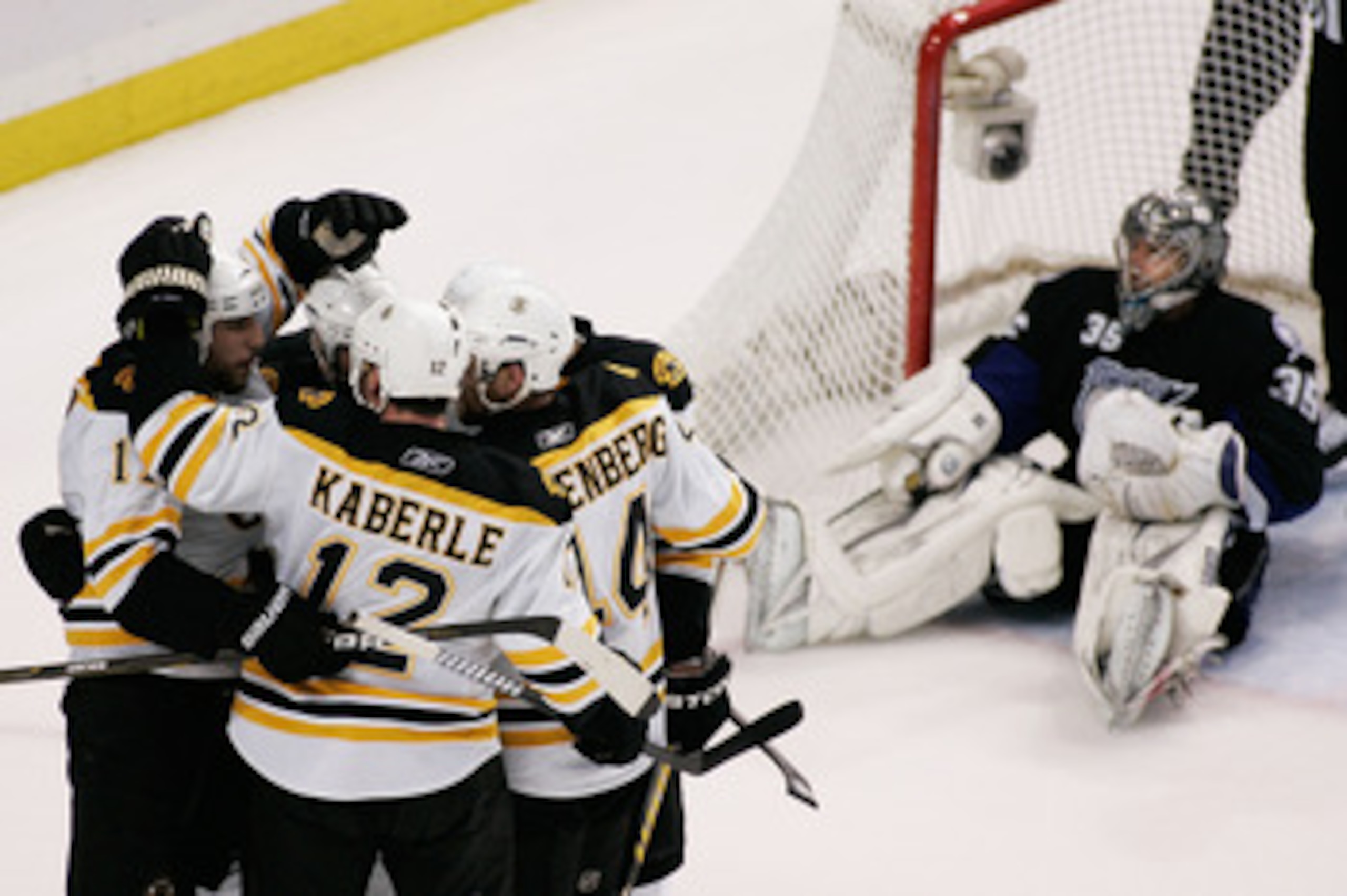 TAMPA, FL - MAY 25:  David Krejci #46 of the Boston Bruins celebrates his third period goal with teammates as Dwayne Roloson #35 of the Tampa Bay Lightning reacts in front of the goal in Game Six of the Eastern Conference Finals during the 2011 NHL Stanle