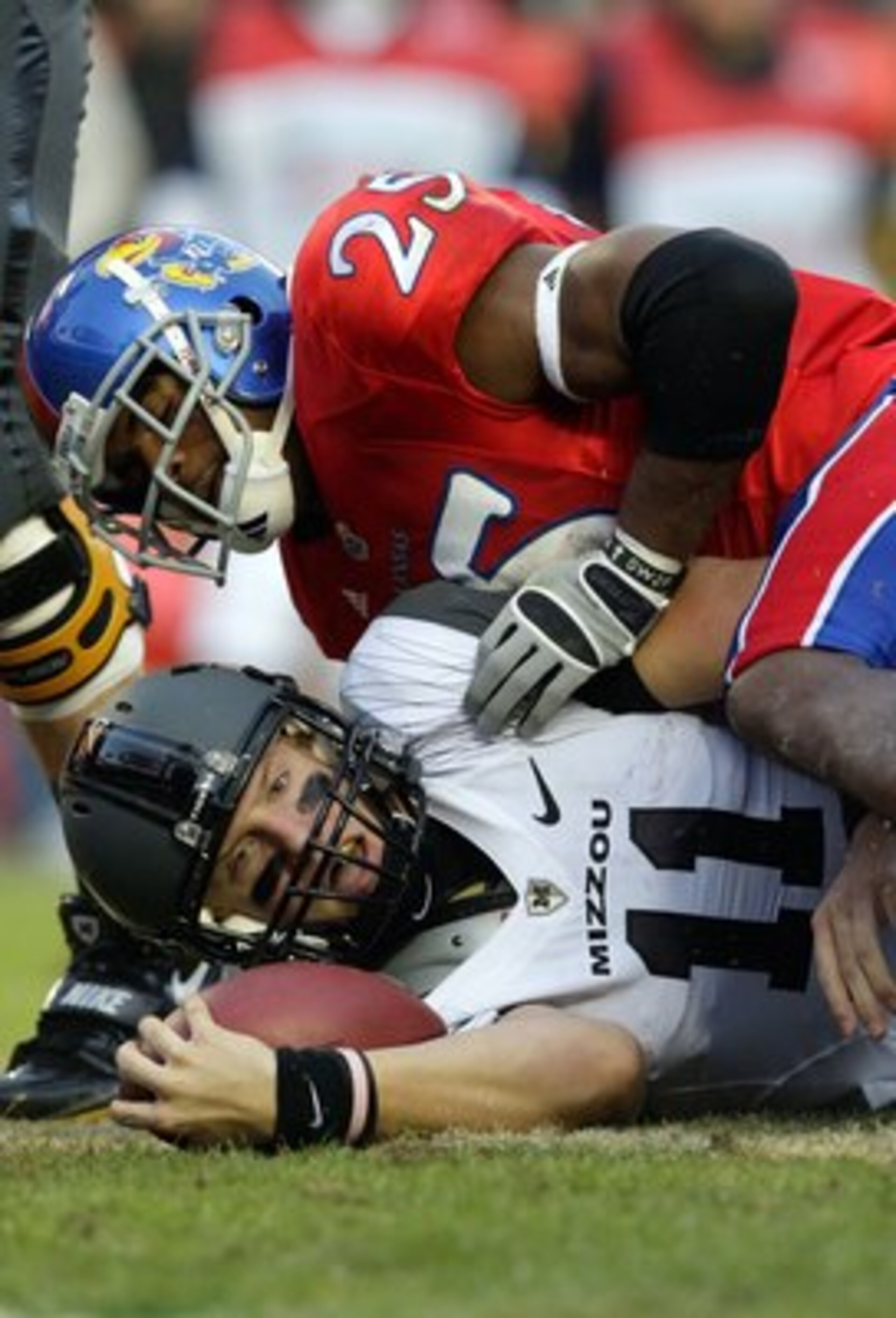 KANSAS CITY, MO - NOVEMBER 28: Quarterback Blaine Gabbert #11 of the Missouri Tigers is tackled short of the end zone by Darrell Stuckey #25 of the Kansas Jayhawks during the game at Arrowhead Stadium on November 28, 2009 in Kansas City, Missouri. (Photo