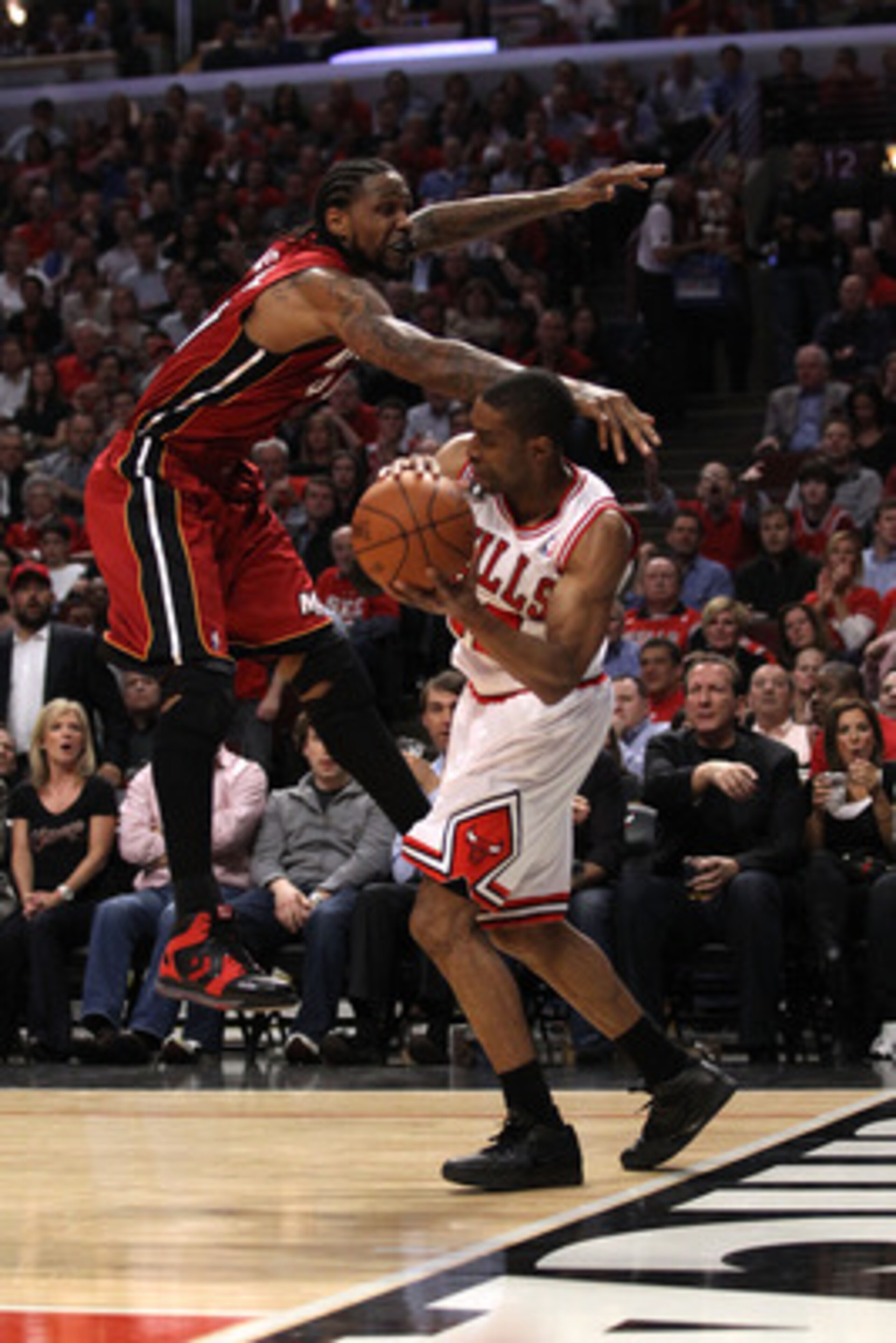 CHICAGO, IL - MAY 18:  Udonis Haslem #40 of the Miami Heat applies defensive pressure against C.J. Watson #32 of the Chicago Bulls in Game Two of the Eastern Conference Finals during the 2011 NBA Playoffs on May 18, 2011 at the United Center in Chicago, I