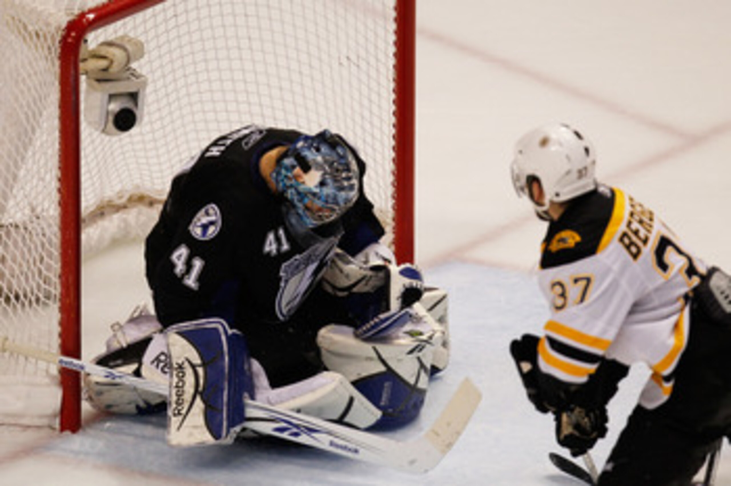 TAMPA, FL - MAY 21:  Mike Smith #41 of the Tampa Bay Lightning makes a save as Patrice Bergeron #37 of the Boston Bruins looks on in Game Four of the Eastern Conference Finals during the 2011 NHL Stanley Cup Playoffs at St Pete Times Forum on May 21, 2011