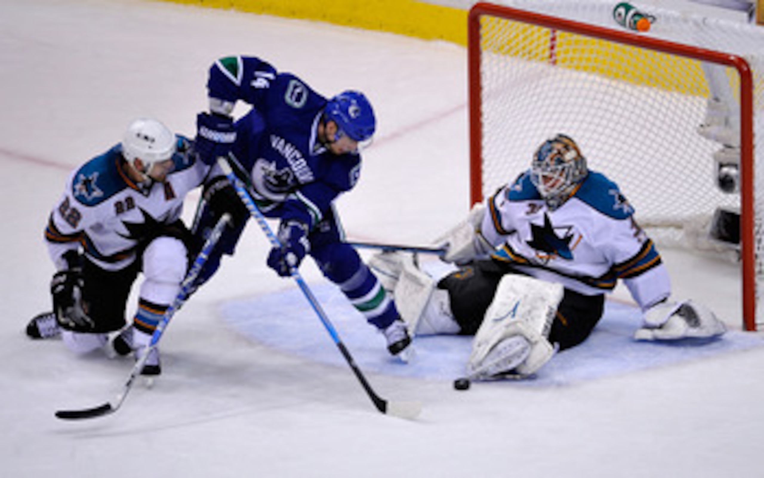 VANCOUVER, CANADA - MAY 24:  Goaltender Antti Niemi #31 of the San Jose Sharks makes a save on a scoring attempt by Alex Burrows #14 of the Vancouver Canucks as teammate Dan Boyle #22 tries to defend the play in the second period in Game Five of the Weste