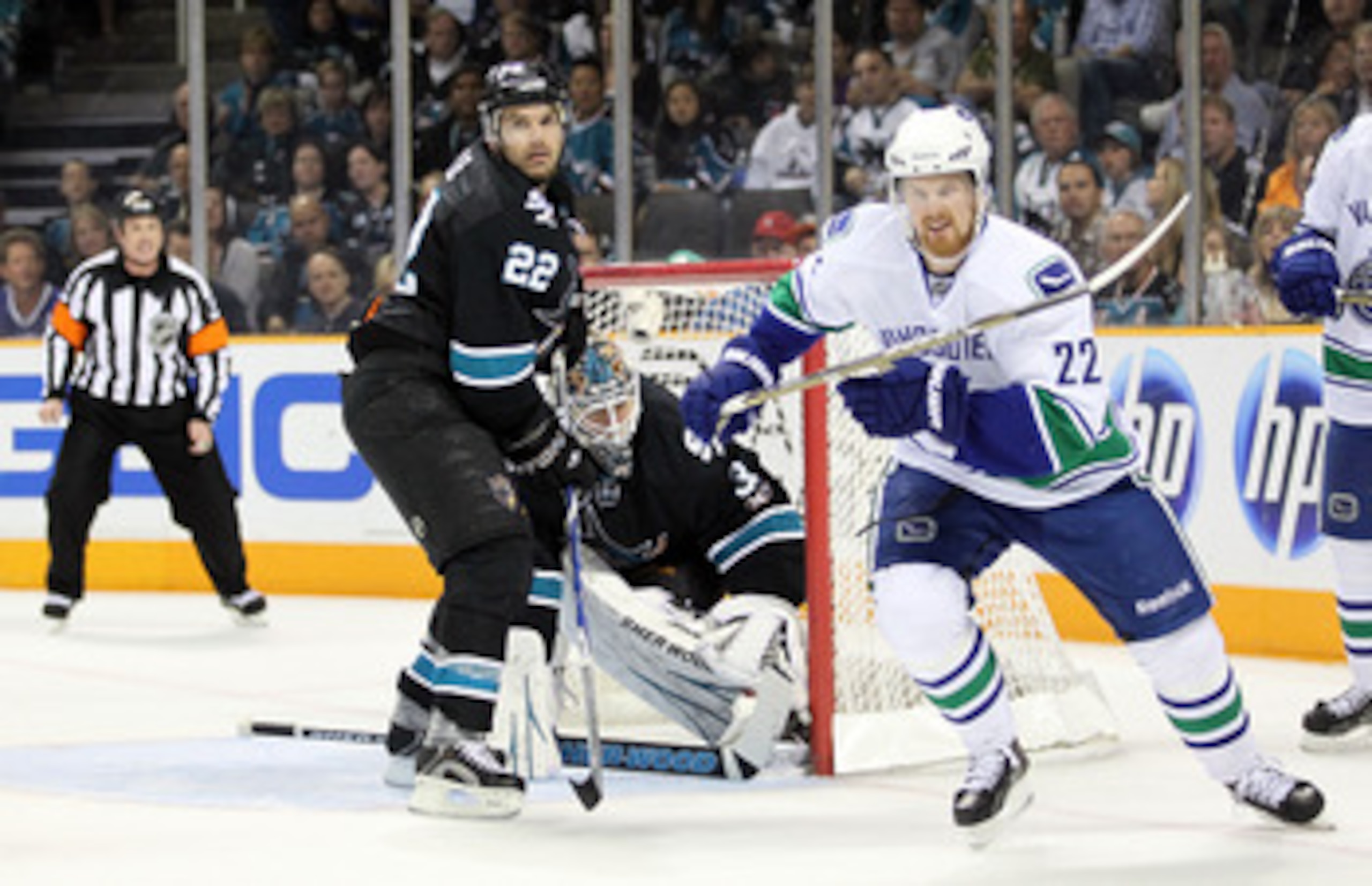 SAN JOSE, CA - MAY 22:  Goaltender Antti Niemi #31 and Dan Boyle #22 of the San Jose Sharks defend their net in Game Four of the Western Conference Finals as Daniel Sedin #22 of the Vancouver Canucks skates away during the 2011 Stanley Cup Playoffs at HP