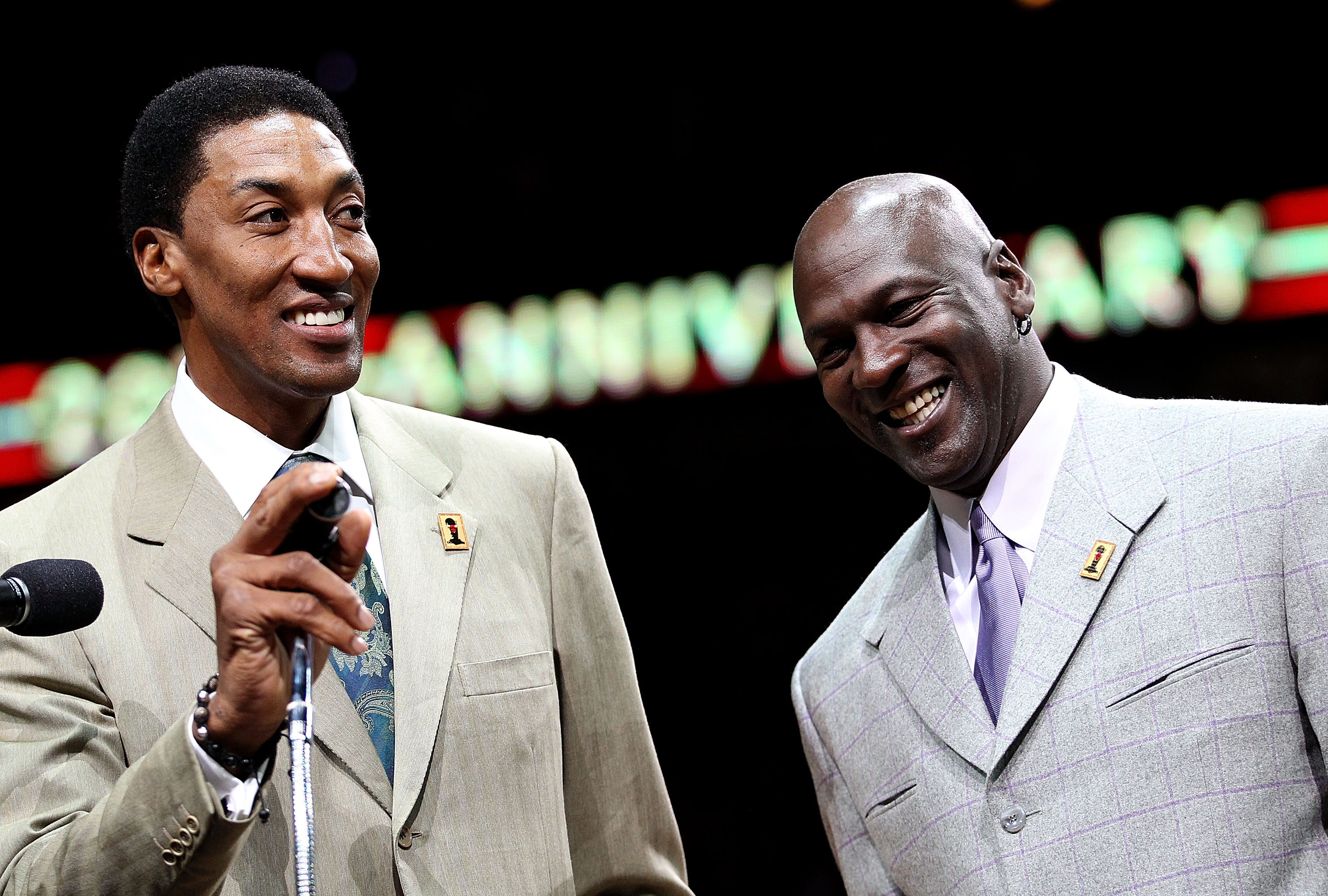 CHICAGO, IL - MARCH 12: Former players Scottie Pippen and Michael Jordan of the Chicago Bulls smile as the crowd cheers during a 20th anniversary recognition ceremony of the Bulls 1st NBA Championship in 1991 during half-time of a game bewteen the Bulls a