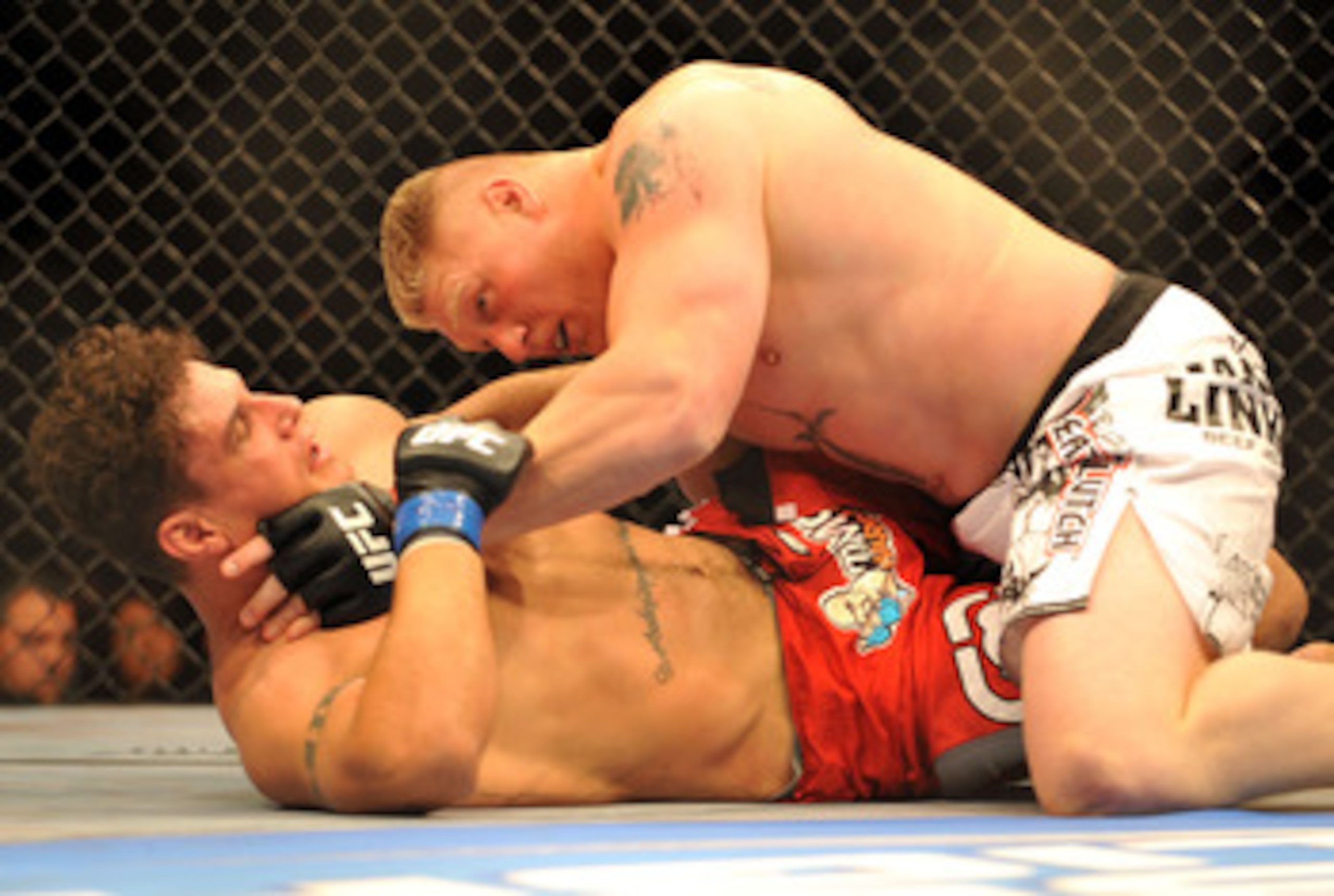 LAS VEGAS - JULY 11: Brock Lesnar holds down Frank Mir during their heavyweight title bout during UFC 100 on July 11, 2009 in Las Vegas, Nevada. (Photo by Jon Kopaloff/Getty Images) LAS VEGAS - JULY 11: Brock Lesnar holds down Frank Mir during their heavyweight title bout during UFC 100 on July 11, 2009 in Las Vegas, Nevada. (Photo by Jon Kopaloff/Getty Images)