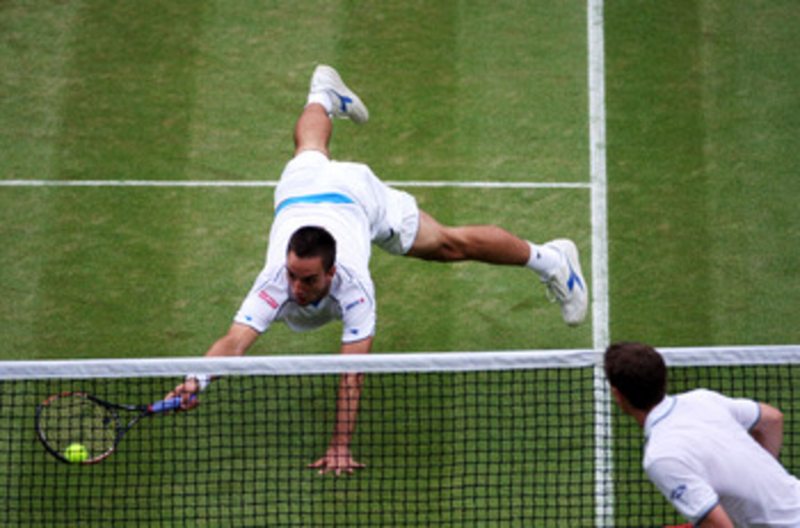 WIMBLEDON, ENGLAND - JUNE 27:  Viktor Troicki of Serbia dives to play a forehand during the men's singles third round match against Andy Murray of Great Britain on Day Six of the Wimbledon Lawn Tennis Championships at the All England Lawn Tennis and Croqu