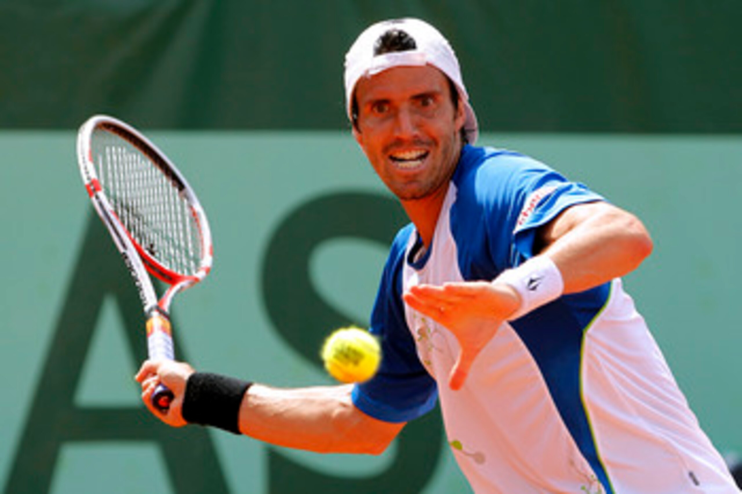 PARIS, FRANCE - MAY 28: Juan Ignacio Chela of Argentina hits a forehand during the men's singles round three match between Juan Ignacio Chela of Argentina and Lukas Rosol of Czech Republic on day seven of the French Open at Roland Garros on May 28, 2011 i