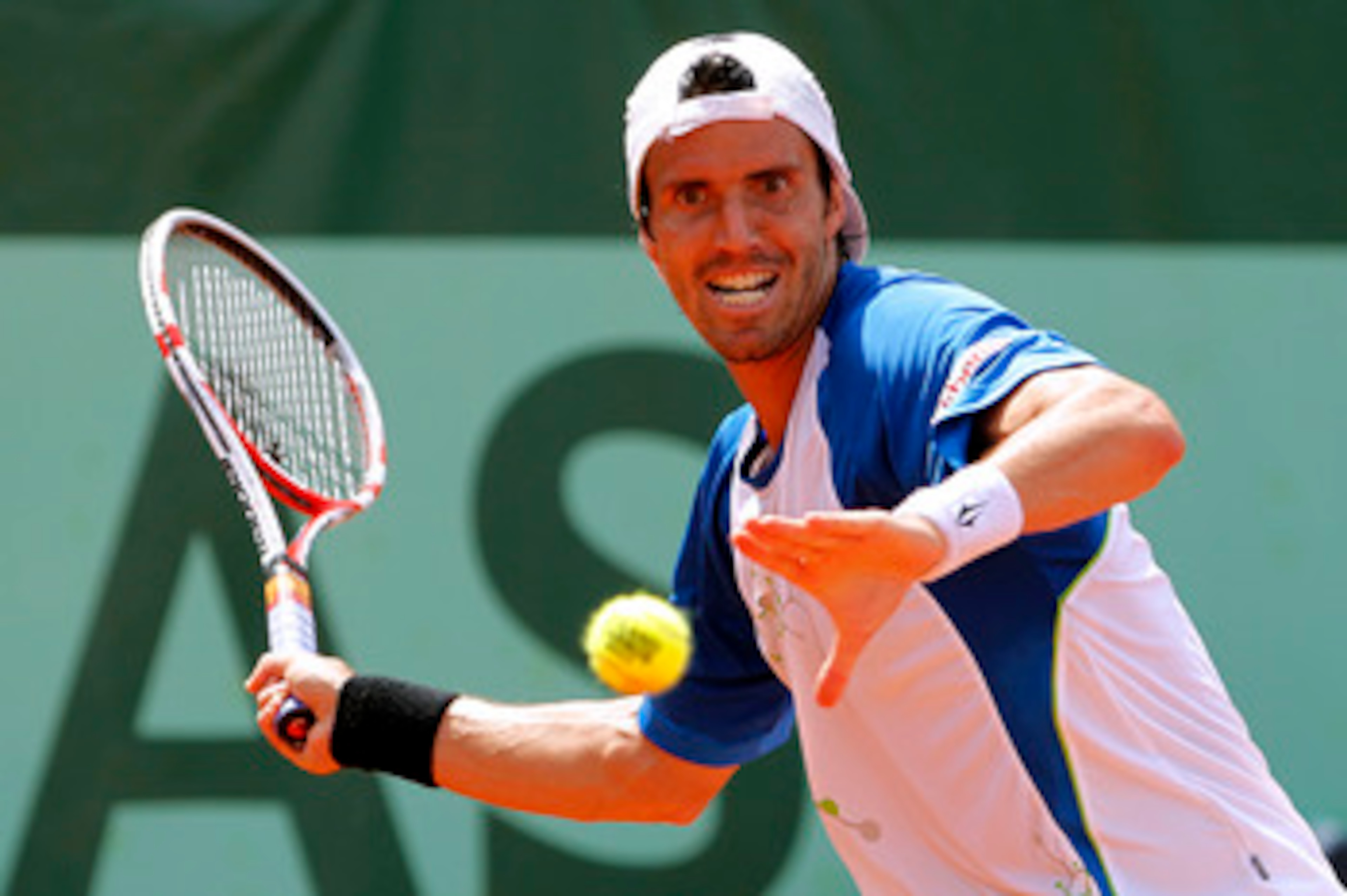 PARIS, FRANCE - MAY 28: Juan Ignacio Chela of Argentina hits a forehand during the men's singles round three match between Juan Ignacio Chela of Argentina and Lukas Rosol of Czech Republic on day seven of the French Open at Roland Garros on May 28, 2011 i