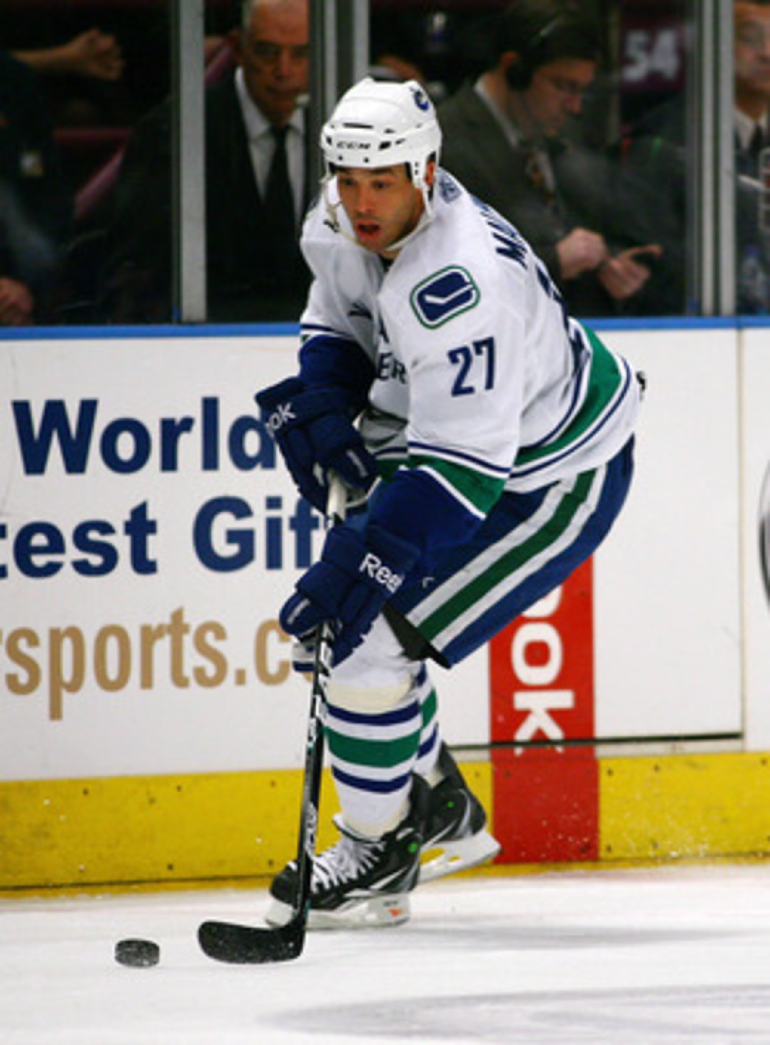 NEW YORK , NY - JANUARY 13: Manny Malhotra #27 of the Vancouver Canucks plays the puck against the New York Rangers during the game at Madison Square Garden on January 13, 2011 in New York City. (Photo by Andy Marlin/Getty Images)