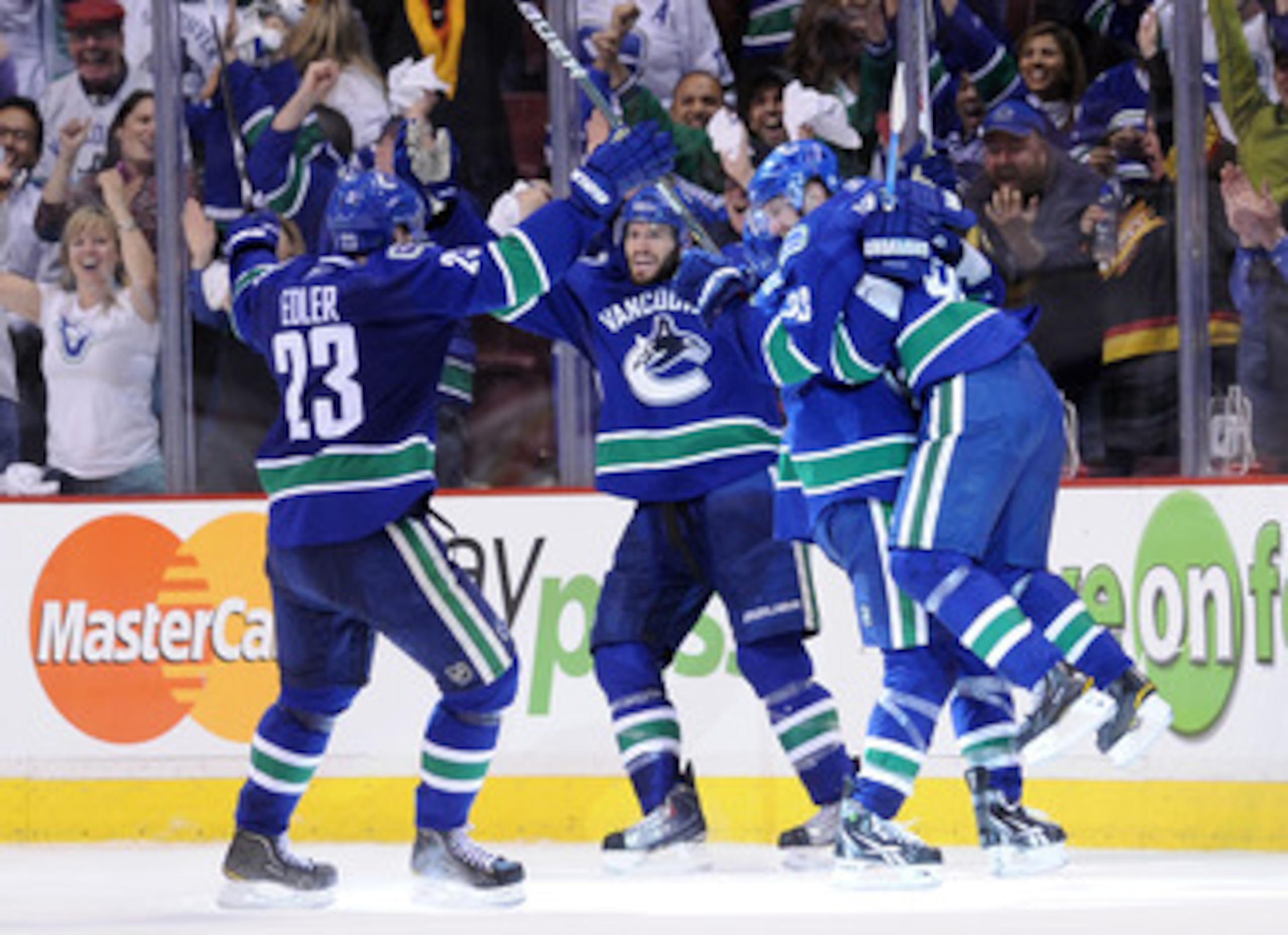 VANCOUVER, CANADA - MAY 24:  (L-R) Alexander Edler #23, Ryan Kesler #17, Alex Burrows #14 and Daniel Sedin #22 of the Vancouver Canucks celebrate Kesler's game tying goal with less than 14 seconds in the third period to send the game into overtime in Game