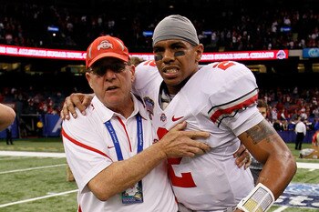 NEW ORLEANS, LA - JANUARY 04:  (M) Quarterback Terrelle Pryor #2 of the Ohio State Buckeyes is helped off the field by a member of the Buckeyes support team after the Buckeyes 31-26 victory against the Arkansas Razorbacks during the Allstate Sugar Bowl at