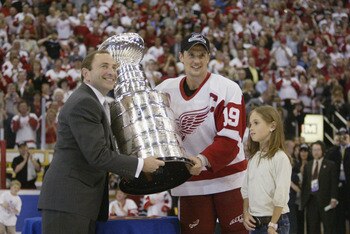 DETROIT, MI - JUNE 13:  Commisioner Gary Bettman presents the Stanley Cup to captain Steve Yzerman of the Detroit Red Wings with his daughter Isabella after eliminating the Carolina Hurricanes during game five of the NHL Stanley Cup Finals on June 13, 200