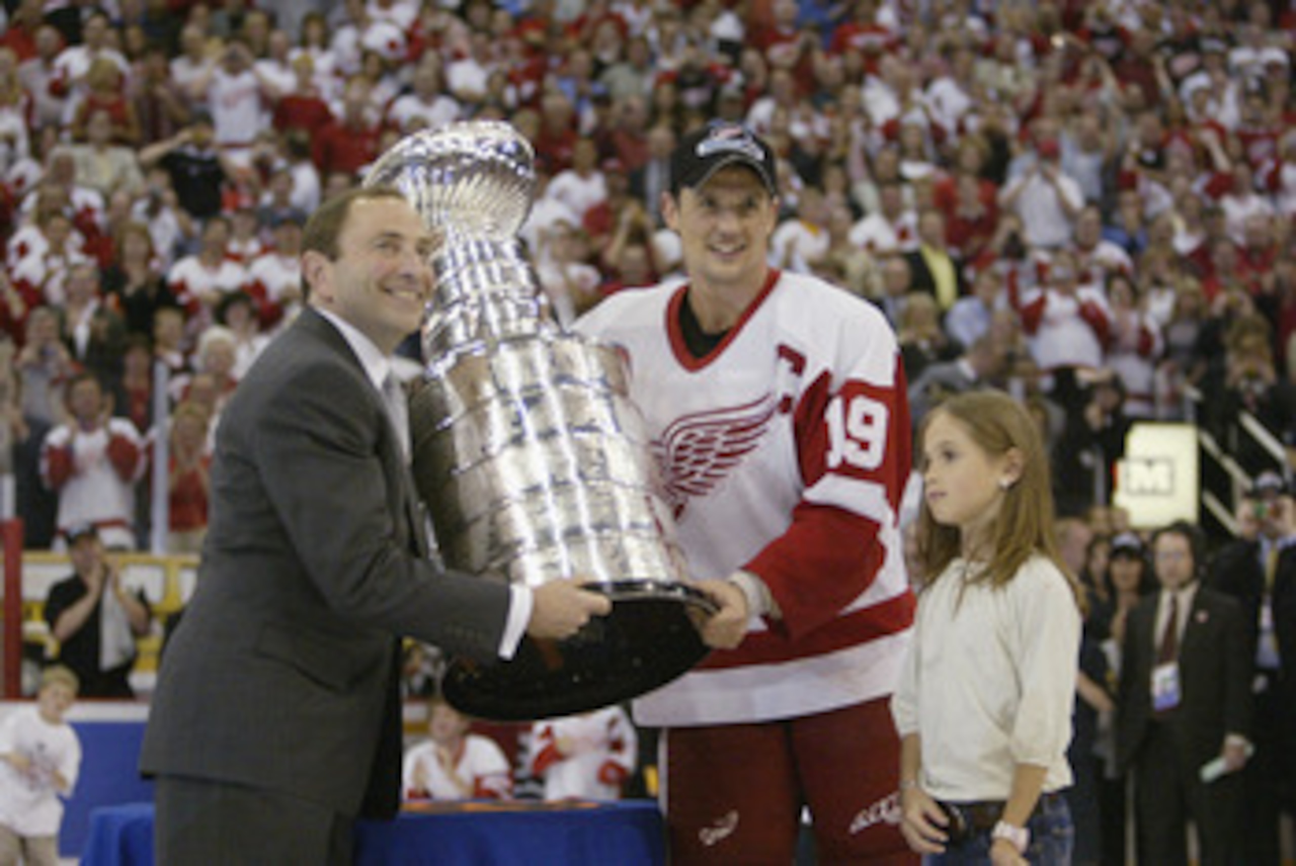 DETROIT, MI - JUNE 13:  Commisioner Gary Bettman presents the Stanley Cup to captain Steve Yzerman of the Detroit Red Wings with his daughter Isabella after eliminating the Carolina Hurricanes during game five of the NHL Stanley Cup Finals on June 13, 200