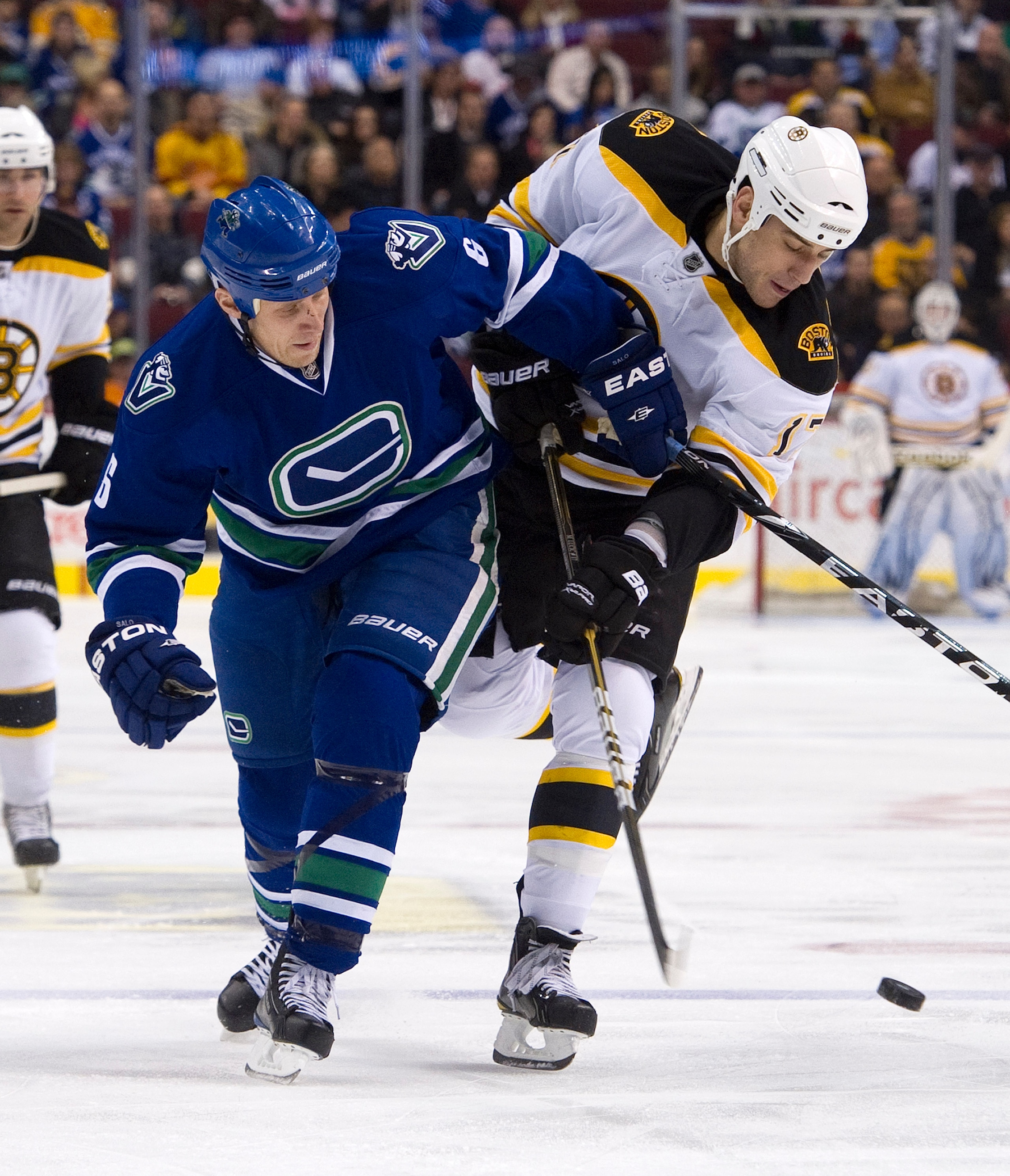 VANCOUVER, CANADA - FEBRUARY 26: Sami Salo #6 of the Vancouver Canucks ties up Milan Lucic #17 of the Boston Bruins during the first period in NHL action on February 26, 2011 at Rogers Arena in Vancouver, British Columbia, Canada.  (Photo by Rich Lam/Gett