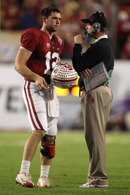 MIAMI, FL - JANUARY 03:  (L-R) Quarterback Andrew Luck and head coach Jim Harbaugh of the Stanford Cardinal talk against the Virginia Tech Hokies during the 2011 Discover Orange Bowl at Sun Life Stadium on January 3, 2011 in Miami, Florida. Stanford won 4