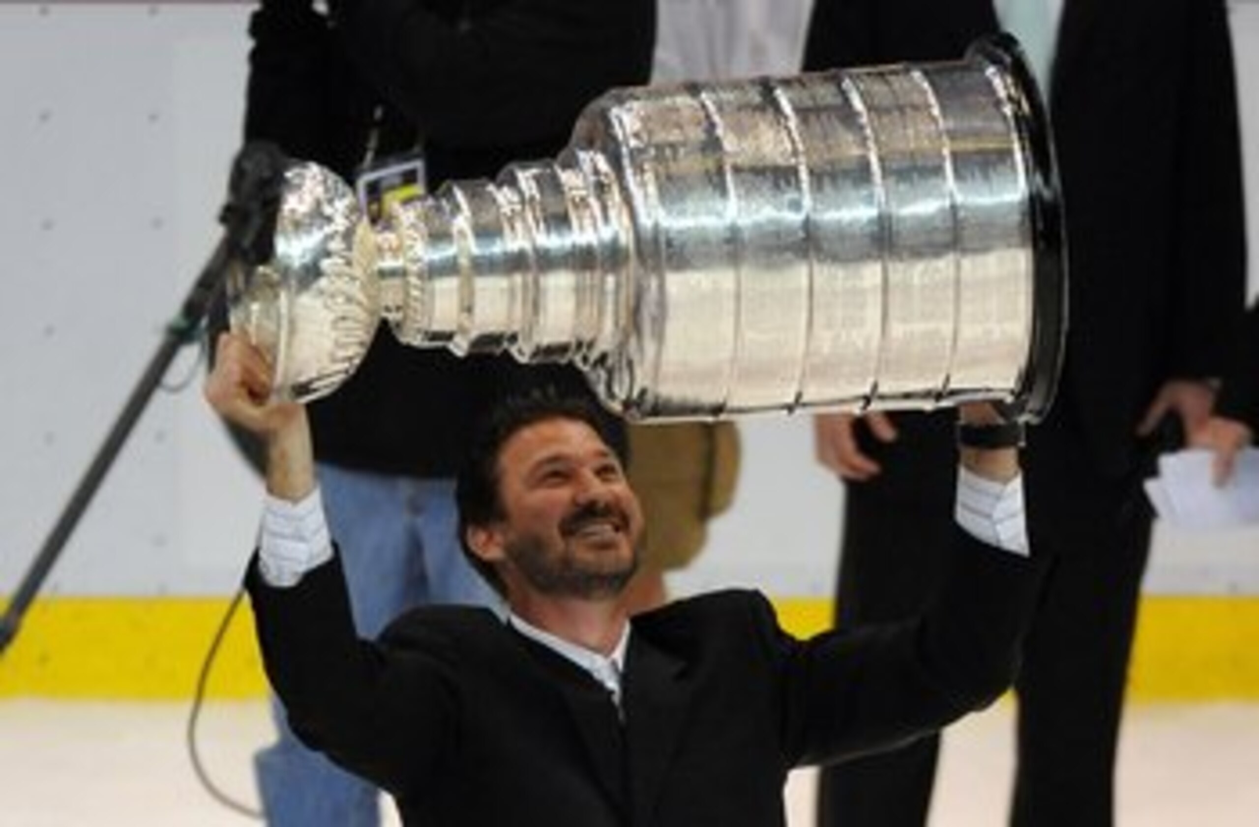 DETROIT - JUNE 12:  Co-Ownter and Chairman Mario Lemieux of the Pittsburgh Penguins hoists the Stanley Cup overhead after Game Seven of the 2009 NHL Stanley Cup Finals against the Detroit Red Wings at Joe Louis Arena on June 12, 2009 in Detroit, Michigan.