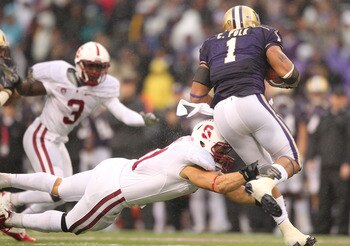 SEATTLE - OCTOBER 30:  Running back Chris Polk #1 of the Washington Huskies rushes against Shayne Skov #11 of the Stanford Cardinal on October 30, 2010 at Husky Stadium in Seattle, Washington. Stanford won 41-0. (Photo by Otto Greule Jr/Getty Images)