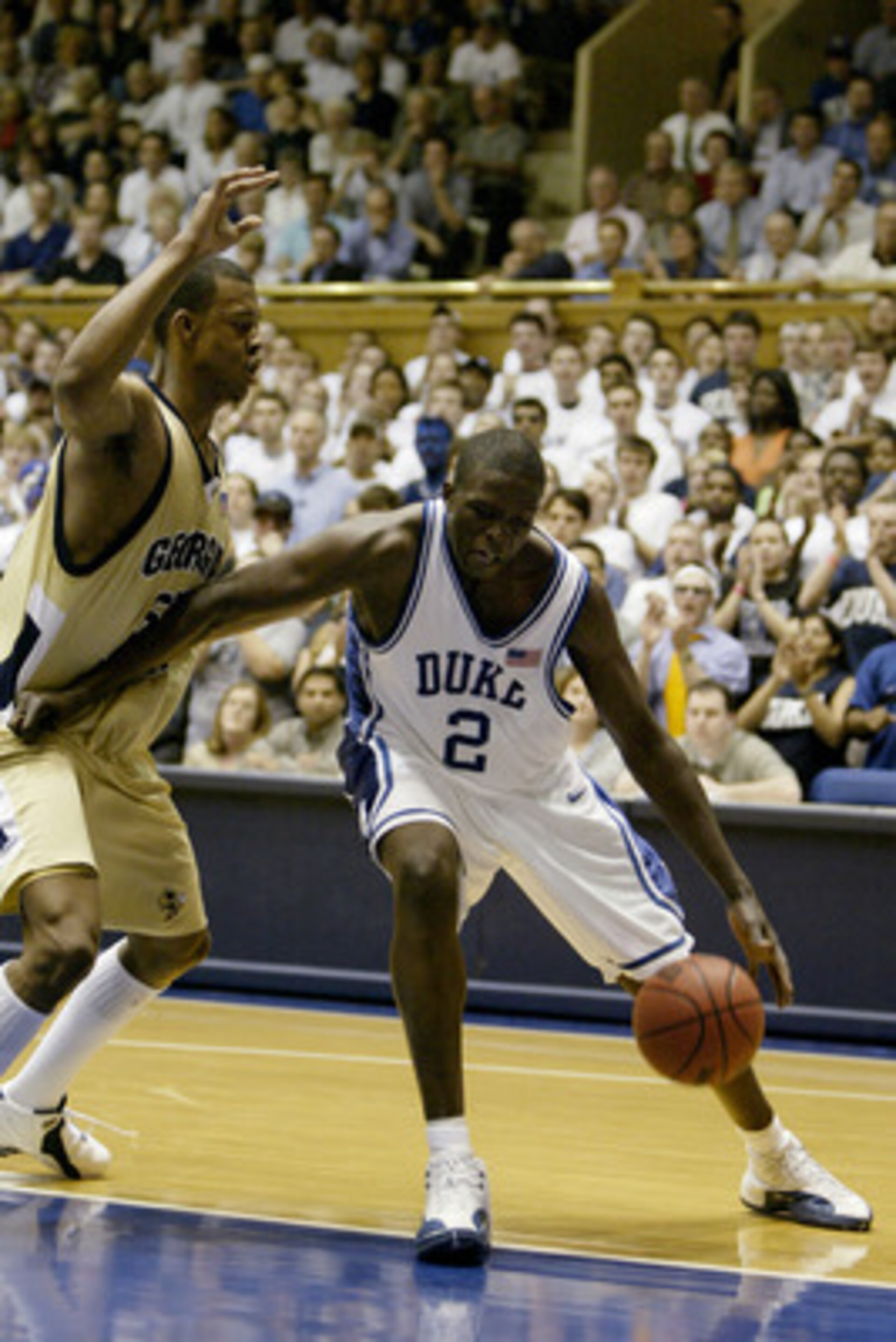 DURHAM, NC - MARCH 3: Luol Deng #2 of the Duke Blue Devils posts up Anthony McHenry #55 of the Georgia Tech Yellow Jackets during the game on March 3, 2004 at Cameron Indoor Stadium in Durham, North Carolina. The Yellow Jackets won 76-68. (Photo by Stree DURHAM, NC - MARCH 3: Luol Deng #2 of the Duke Blue Devils posts up Anthony McHenry #55 of the Georgia Tech Yellow Jackets during the game on March 3, 2004 at Cameron Indoor Stadium in Durham, North Carolina. The Yellow Jackets won 76-68. (Photo by Stree