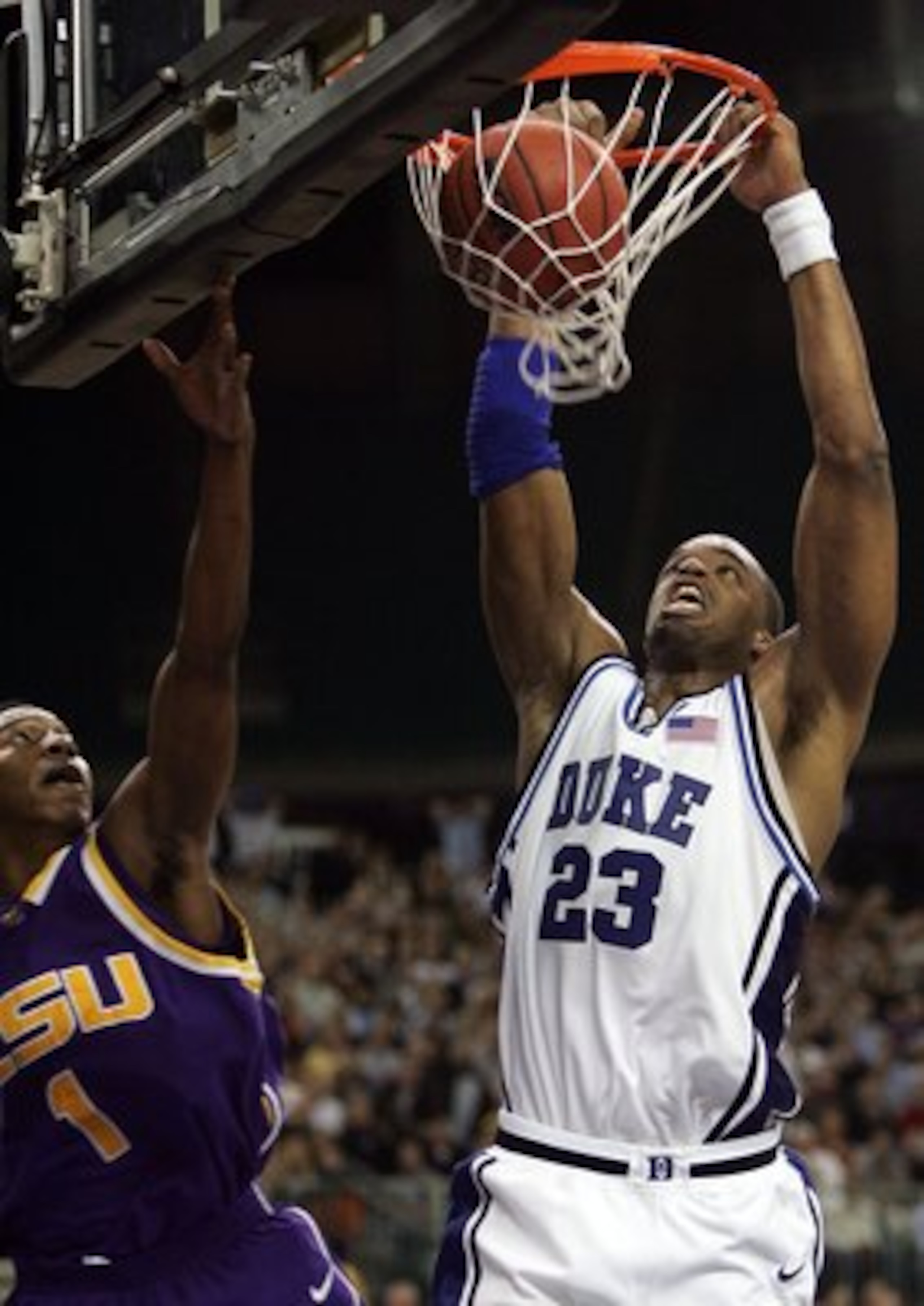 ATLANTA - MARCH 23: Shelden Williams #23 of the Duke Blue Devils dunks over the defense of Tasmin Mitchell #1 of the LSU Tigers during third round game of the 2006 NCAA Division I Men's Basketball Tournament Regional at the Georgia Dome on March 23, 2006 ATLANTA - MARCH 23: Shelden Williams #23 of the Duke Blue Devils dunks over the defense of Tasmin Mitchell #1 of the LSU Tigers during third round game of the 2006 NCAA Division I Men's Basketball Tournament Regional at the Georgia Dome on March 23, 2006