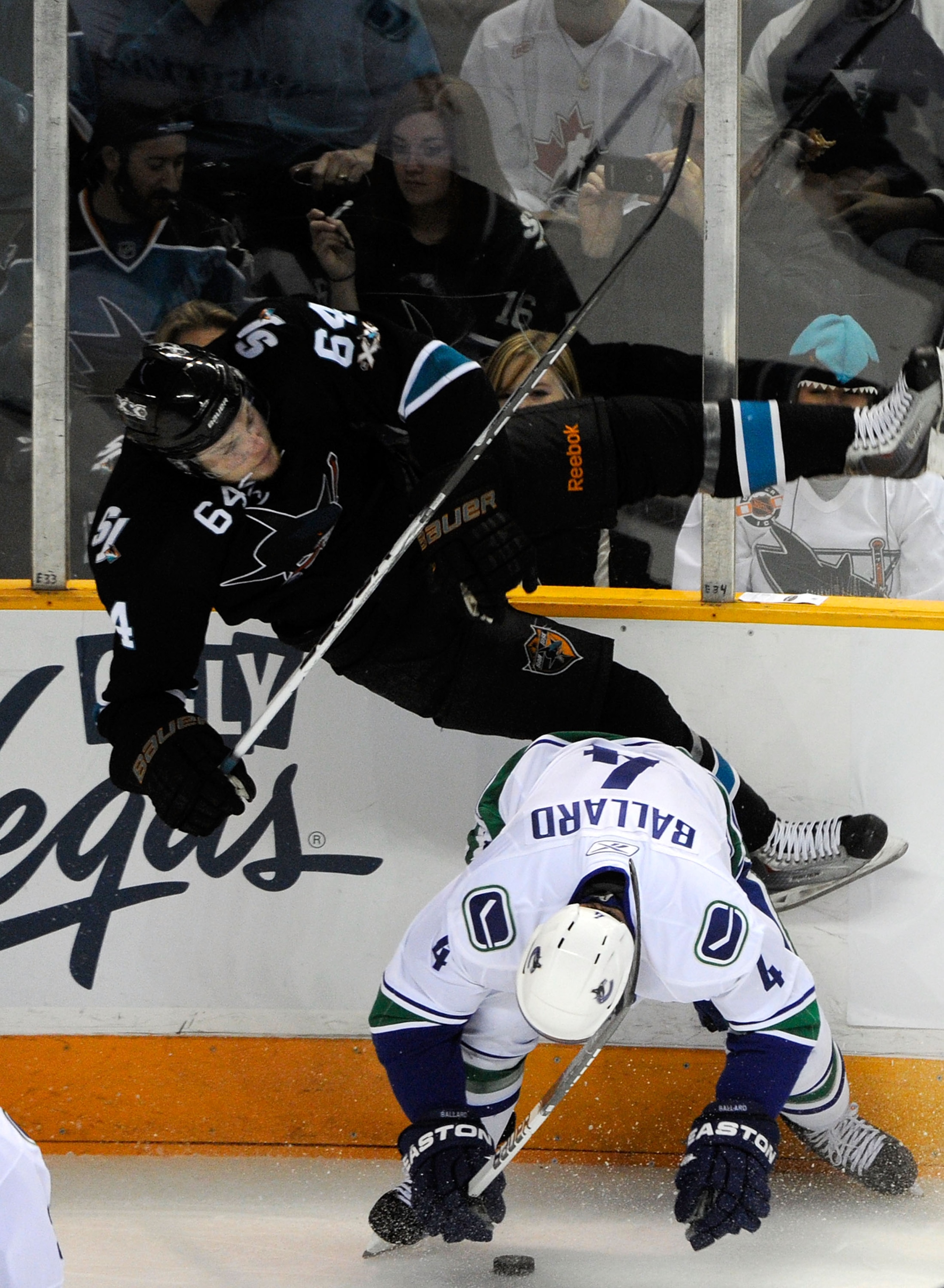 SAN JOSE, CA - MAY 22:  Keith Ballard #4 of the Vancouver Canucks throws the hip check on Jamie McGinn #64 of the San Jose Sharks in the second period in Game Four of the Western Conference Finals during the 2011 Stanley Cup Playoffs at HP Pavilion on May