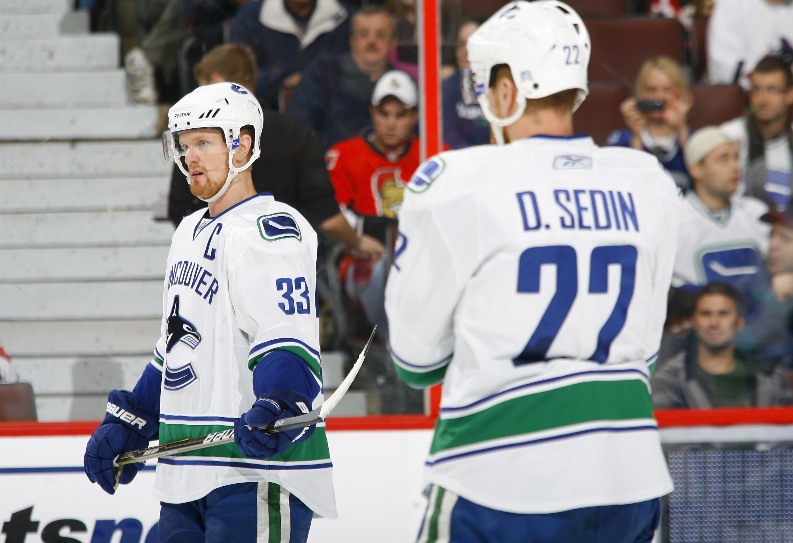 OTTAWA, CANADA - NOVEMBER 11:  Henrik Sedin #33 of the Vancouver Canucks prepares to take a faceoff while teammate Daniel Sedin #22 looks on during a game against the Ottawa Senators at Scotiabank Place on November 11, 2010 in Ottawa, Ontario, Canada.  (P