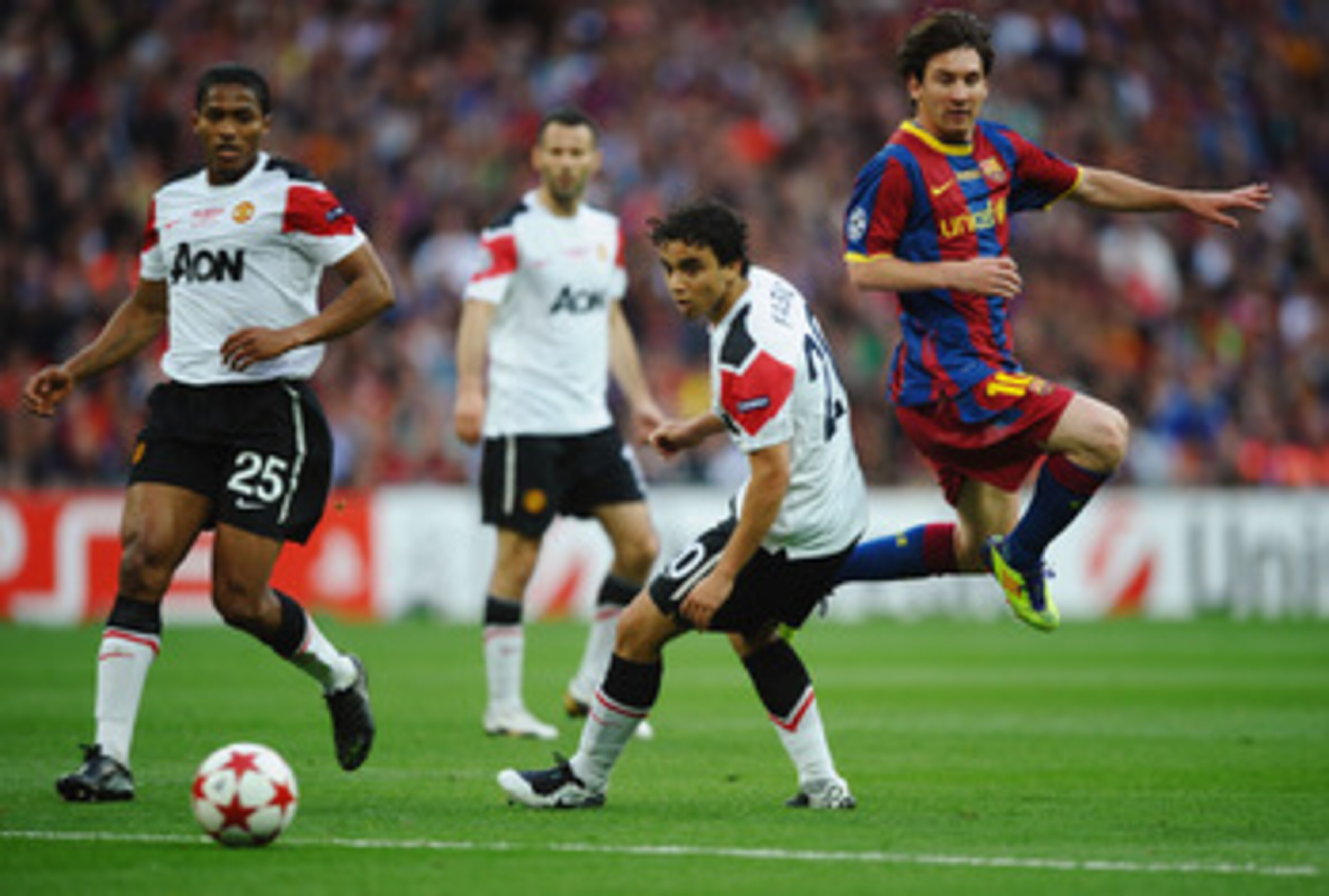 LONDON, ENGLAND - MAY 28: Luis Antonio Valencia of Manchester United (L) and teammate Fabio da Silva (C) look on as Lionel Messi of FC Barcelona (R) takes a shot during the UEFA Champions League final between FC Barcelona and Manchester United FC at Wem LONDON, ENGLAND - MAY 28: Luis Antonio Valencia of Manchester United (L) and teammate Fabio da Silva (C) look on as Lionel Messi of FC Barcelona (R) takes a shot during the UEFA Champions League final between FC Barcelona and Manchester United FC at Wem