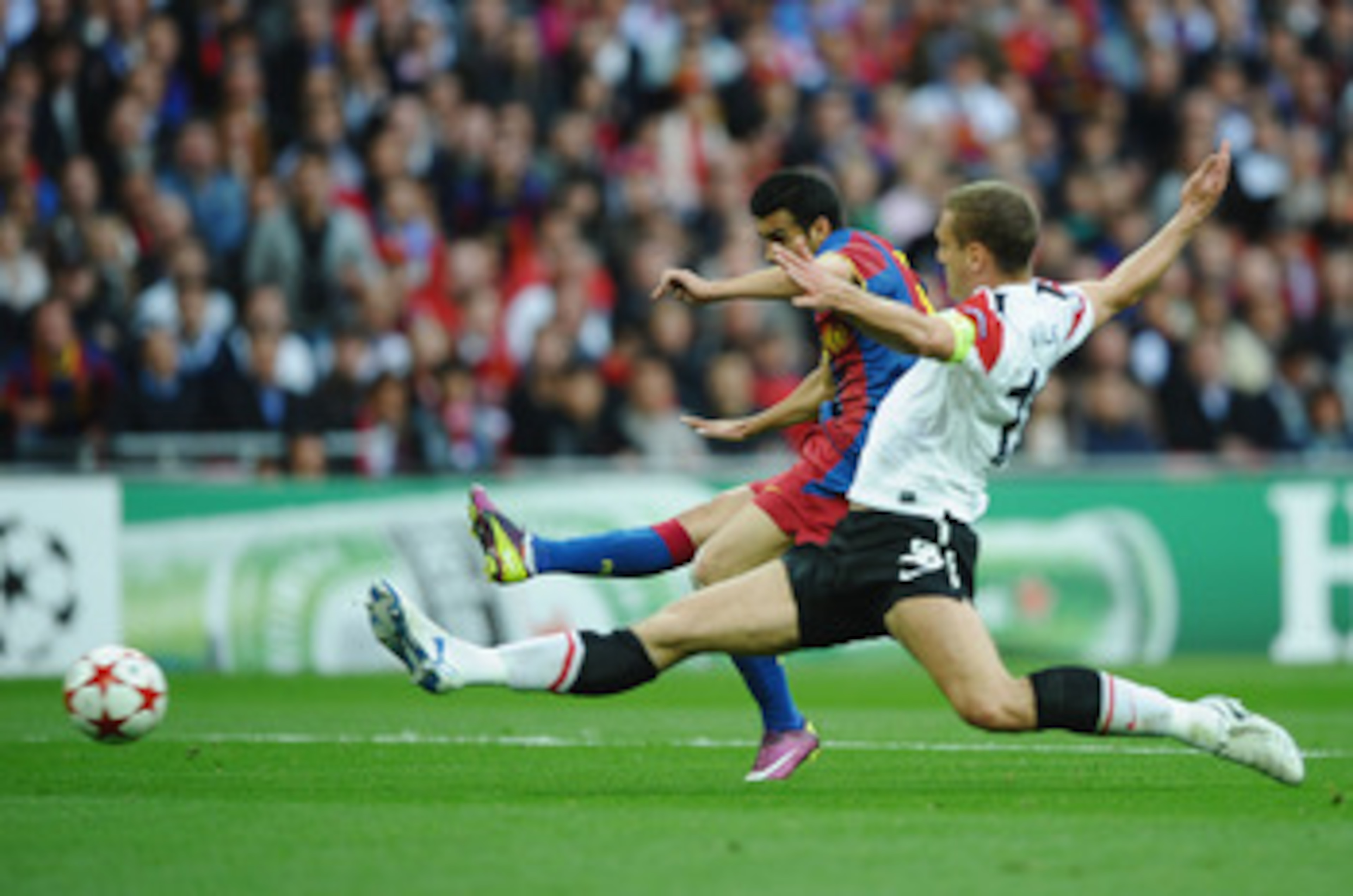 LONDON, ENGLAND - MAY 28: Pedro of FC Barcelona (L) scores the opening goal despite the challenge of Nemanja Vidic of Manchester United during the UEFA Champions League final between FC Barcelona and Manchester United FC at Wembley Stadium on May 28, 201 LONDON, ENGLAND - MAY 28: Pedro of FC Barcelona (L) scores the opening goal despite the challenge of Nemanja Vidic of Manchester United during the UEFA Champions League final between FC Barcelona and Manchester United FC at Wembley Stadium on May 28, 201