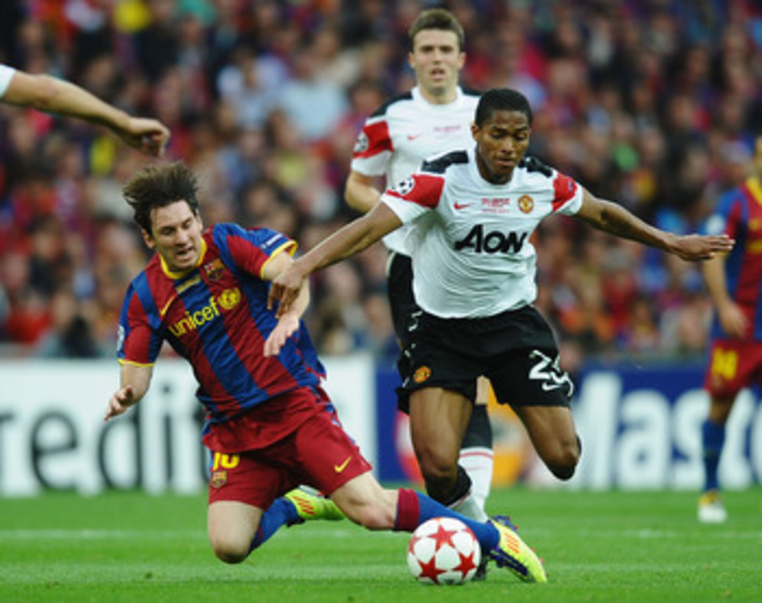 LONDON, ENGLAND - MAY 28:  Lionel Messi of FC Barcelona (L) is challenged by Luis Antonio Valencia of Manchester United during the UEFA Champions League final between FC Barcelona and Manchester United FC at Wembley Stadium on May 28, 2011 in London, Engl