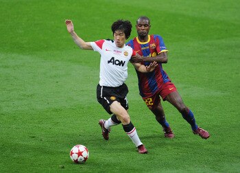 LONDON, ENGLAND - MAY 28:  Park Ji-Sung of Manchester United (L) is challenged by Eric Abidal of FC Barcelona during the UEFA Champions League final between FC Barcelona and Manchester United FC at Wembley Stadium on May 28, 2011 in London, England.  (Pho