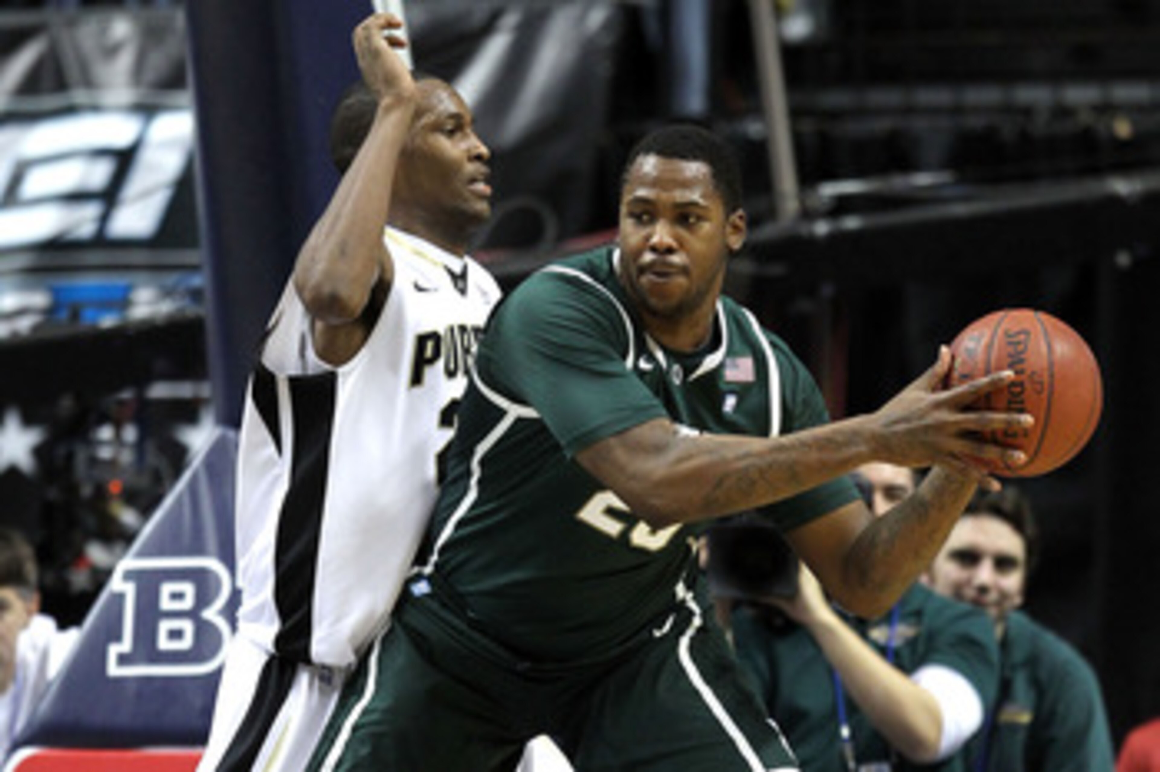 INDIANAPOLIS, IN - MARCH 11:  Derrick Nix #25 of the Michigan State Spartans looks to pass against JaJuan Johnson #25 of the Purdue Boilermakers during the quarterfinals of the 2011 Big Ten Men's Basketball Tournament at Conseco Fieldhouse on March 11, 20